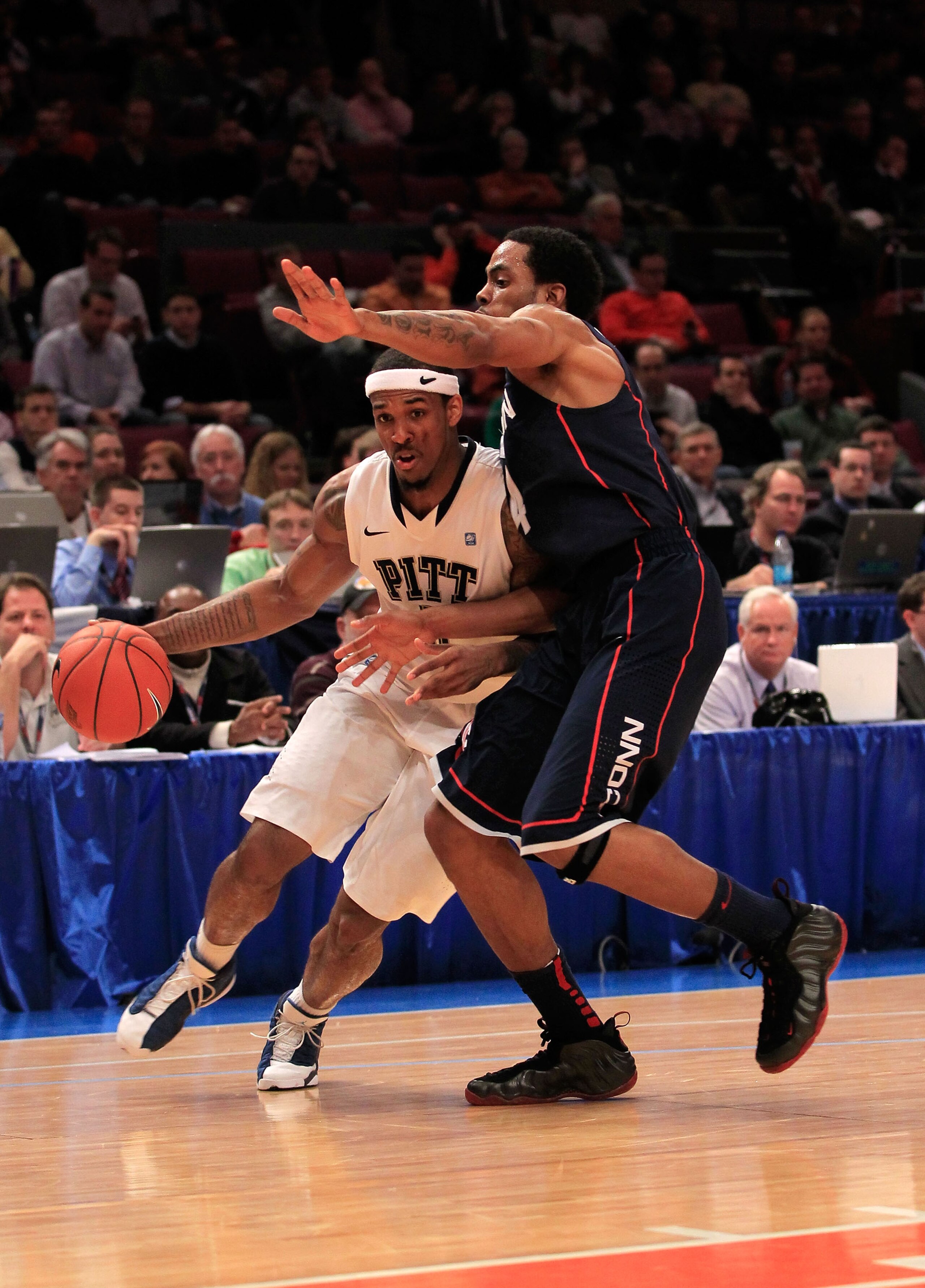 NEW YORK, NY - MARCH 10:  Gilbert Brown #5 of the Pittsburgh Panthers dribbles past Jamal Coombs-McDaniel #4 of the Connecticut Huskies during the quarterfinals of the 2011 Big East Men's Basketball Tournament presented by American Eagle Outfitters  at Ma