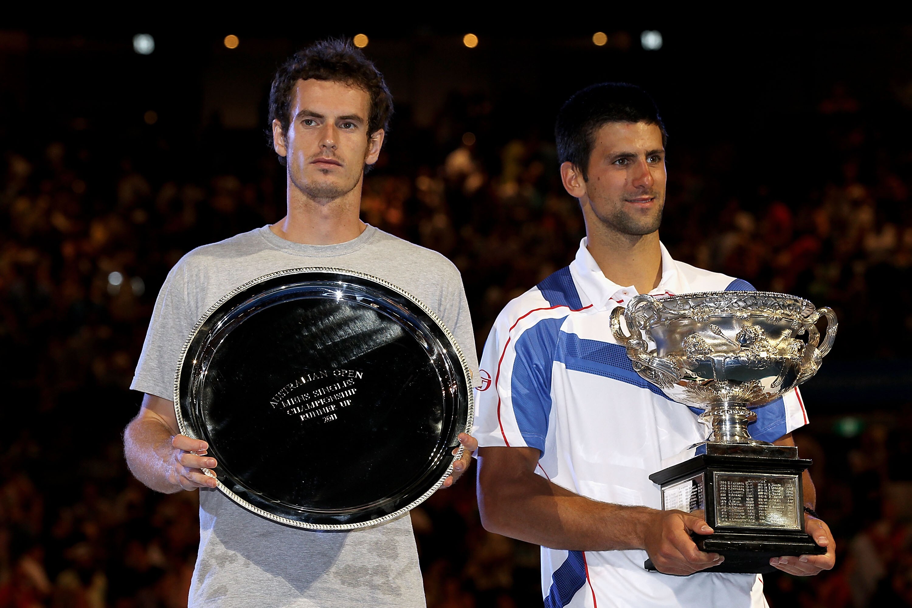 MELBOURNE, AUSTRALIA - JANUARY 30:  Novak Djokovic of Serbia (R) poses with the Norman Brookes Challenge Cup after winning his men's final match against Andy Murray of Great Britain (L) during day fourteen of the 2011 Australian Open at Melbourne Park on