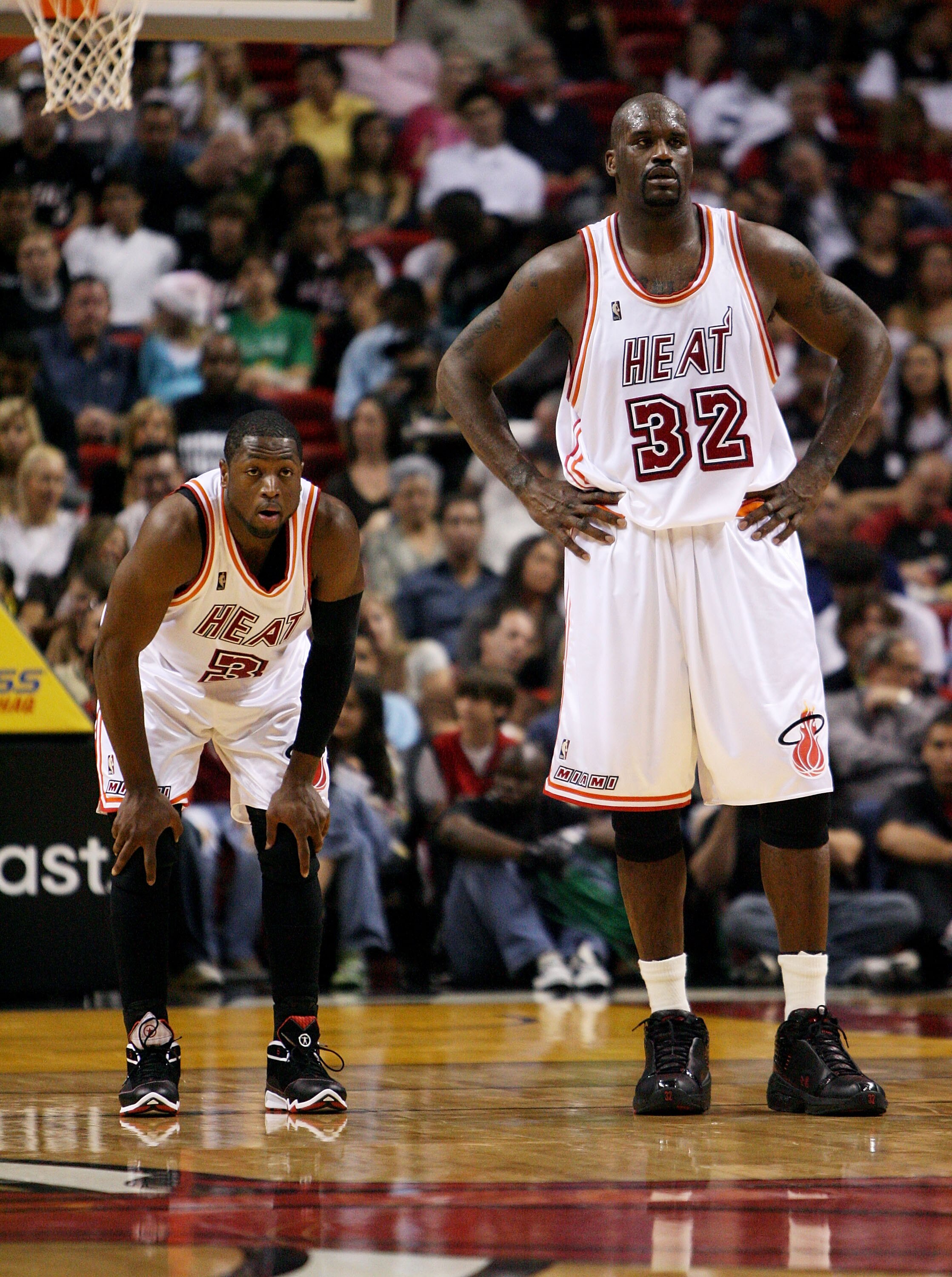 MIAMI - DECEMBER 22:  Dwyane Wade #3 and Shaquille O'Neal #32 of the Miami Heat watch as the Utah Jazz shoot free throws at American Airlines Arena December 22, 2007 in Miami, Florida. The Heat defeated the Jazz 104-102. NOTE TO USER: User expressly ackno