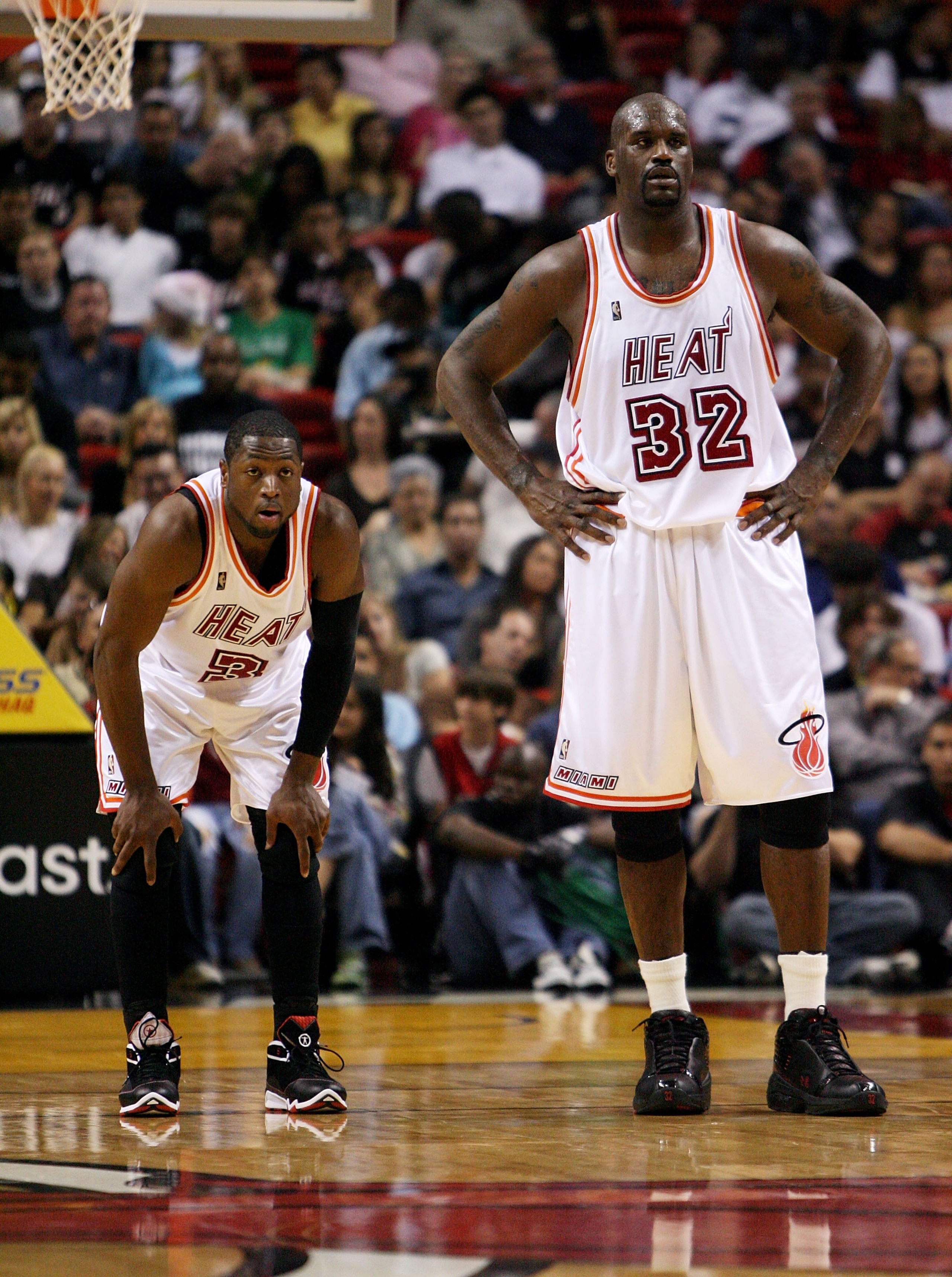 MIAMI - DECEMBER 22:  Dwyane Wade #3 and Shaquille O'Neal #32 of the Miami Heat watch as the Utah Jazz shoot free throws at American Airlines Arena December 22, 2007 in Miami, Florida. The Heat defeated the Jazz 104-102. NOTE TO USER: User expressly ackno