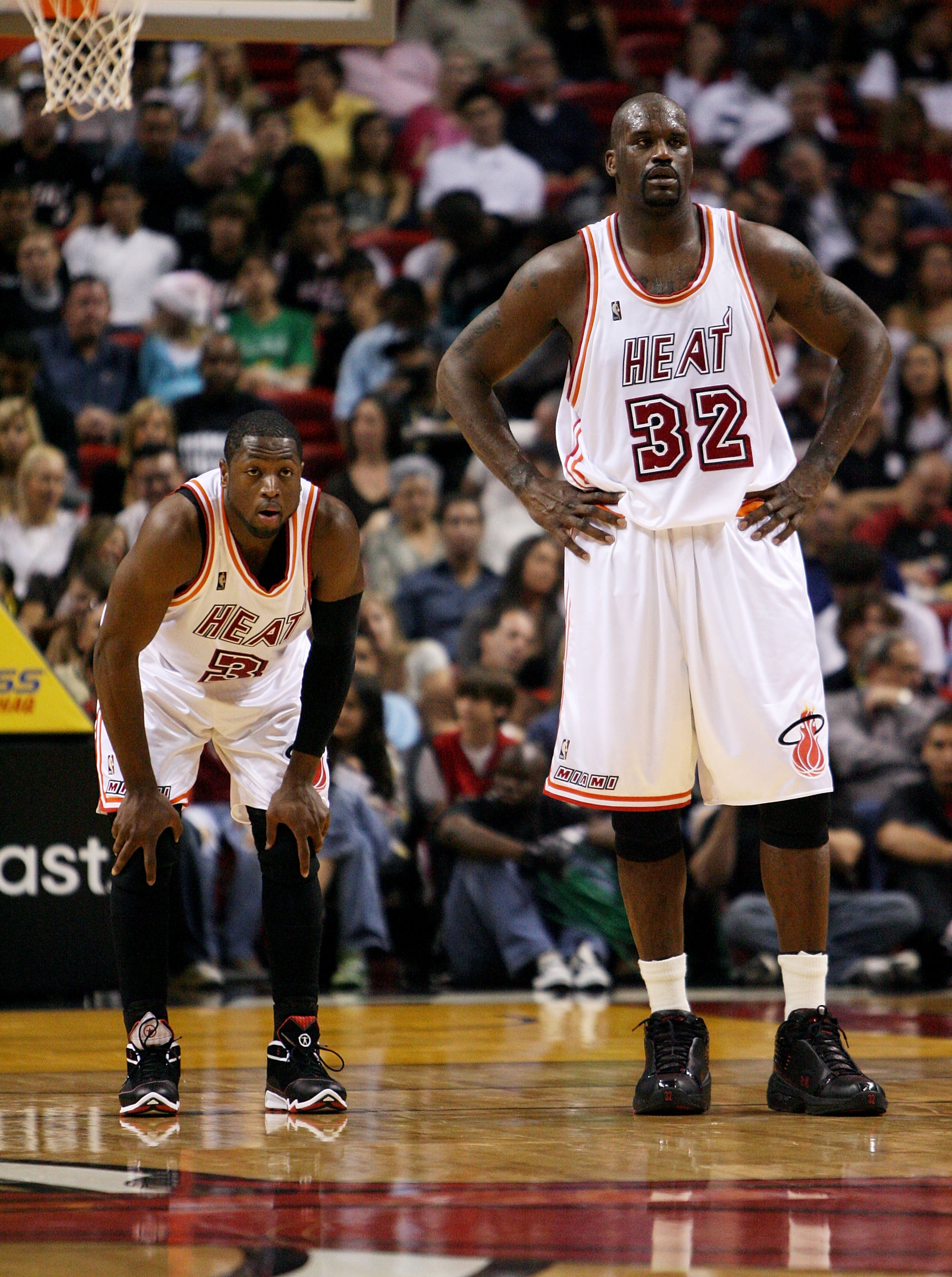 MIAMI - DECEMBER 22:  Dwyane Wade #3 and Shaquille O'Neal #32 of the Miami Heat watch as the Utah Jazz shoot free throws at American Airlines Arena December 22, 2007 in Miami, Florida. The Heat defeated the Jazz 104-102. NOTE TO USER: User expressly ackno