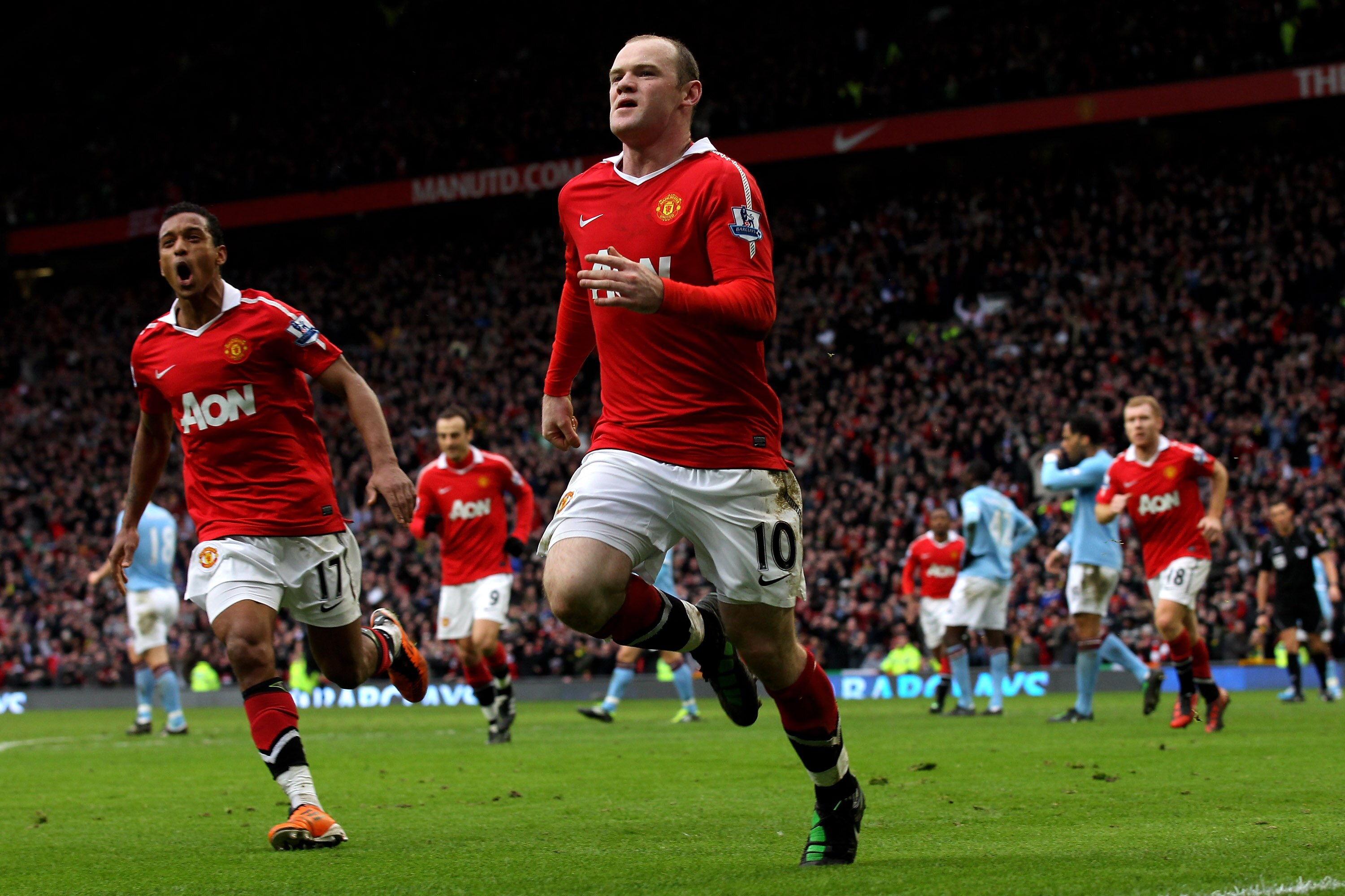 MANCHESTER, ENGLAND - FEBRUARY 12:  Wayne Rooney of Manchester United celebrates with teammate Nani (L) after he scores a goal from an overhead kick during the Barclays Premier League match between Manchester United and Manchester City at Old Trafford on