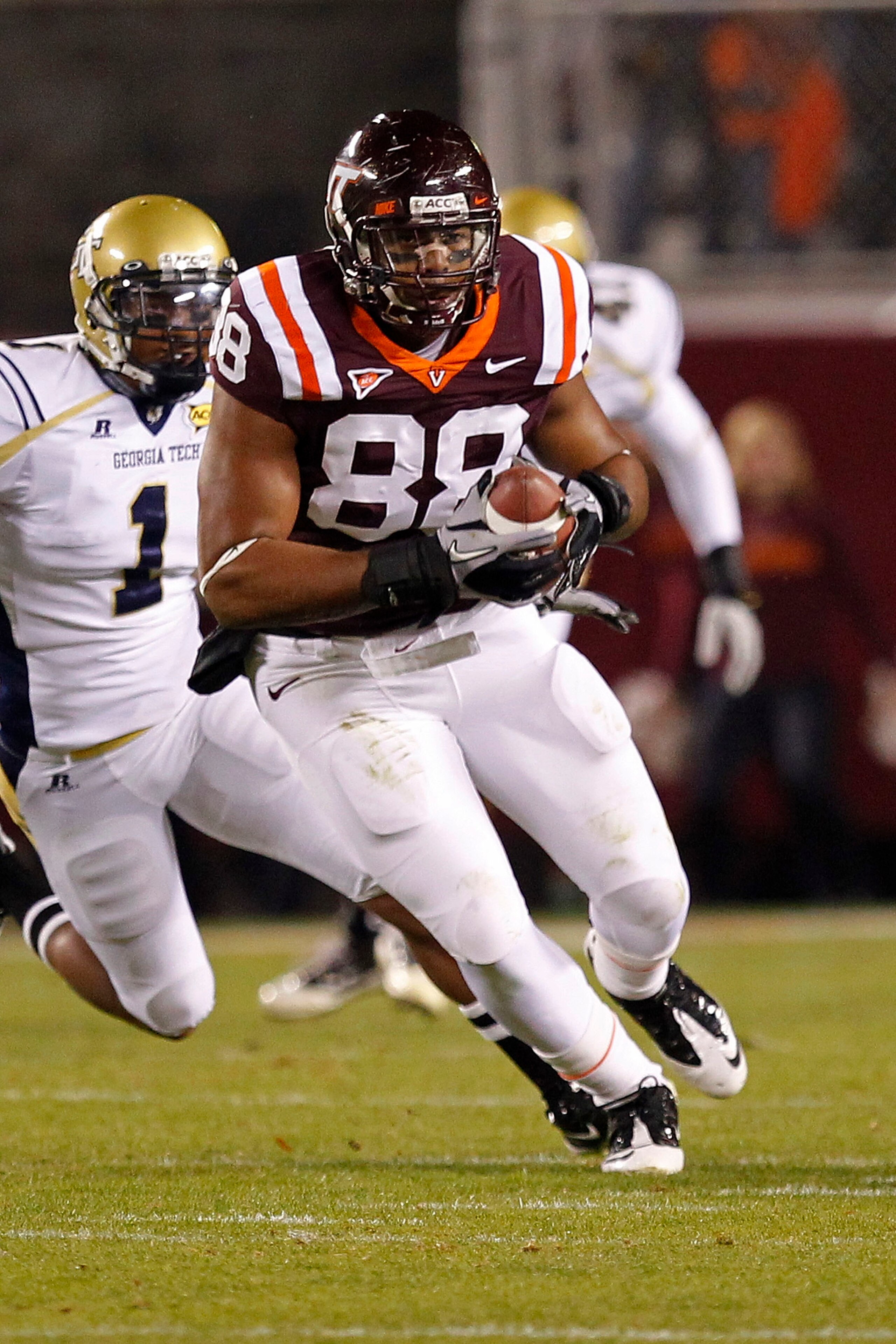 BLACKSBURG, VA - NOVEMBER 04: Tight end Andre Smith #88 of the Virginia Tech Hokies runs with the ball past safety Isaiah Johnson #1 of the Georgia Tech Yellow Jackets at Lane Stadium on November 4, 2010 in Blacksburg, Virginia.  (Photo by Geoff Burke/Get