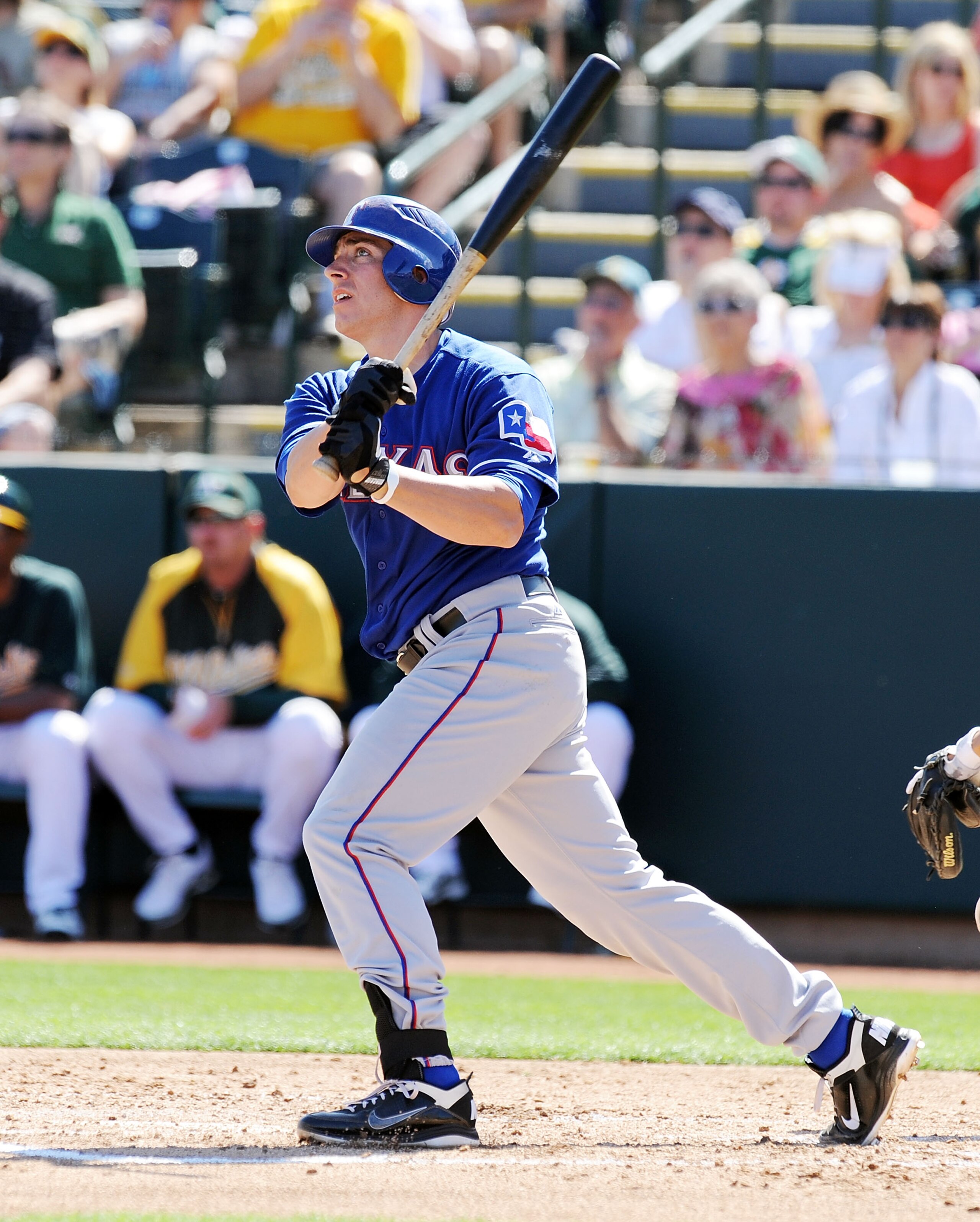 PHOENIX, AZ - MARCH 04:  Taylor Teagarden #2 of the Texas Rangers watches his home run against the Oakland Athletics at Phoenix Municipal Stadium on March 4, 2011 in Phoenix, Arizona.  (Photo by Norm Hall/Getty Images)