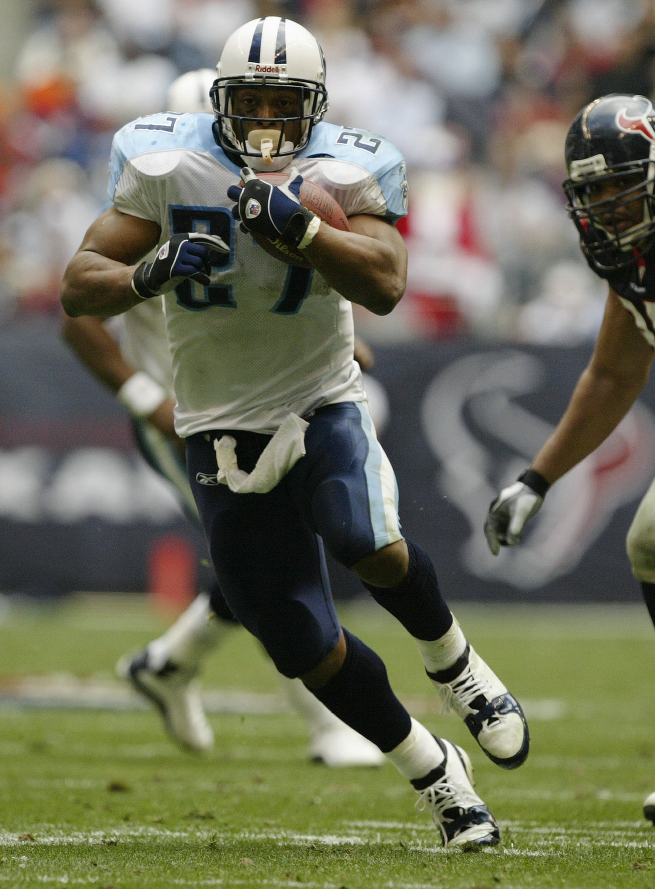 HOUSTON - DECEMBER 21:  Running back Eddie George #27 of the Tennessee Titans runs the ball during the game against the Houston Texans on December 21, 2003 at Reliant Stadium in Houston, Texas.  The Titans won 27-24.   (Photo by Brian Bahr/Getty Images)