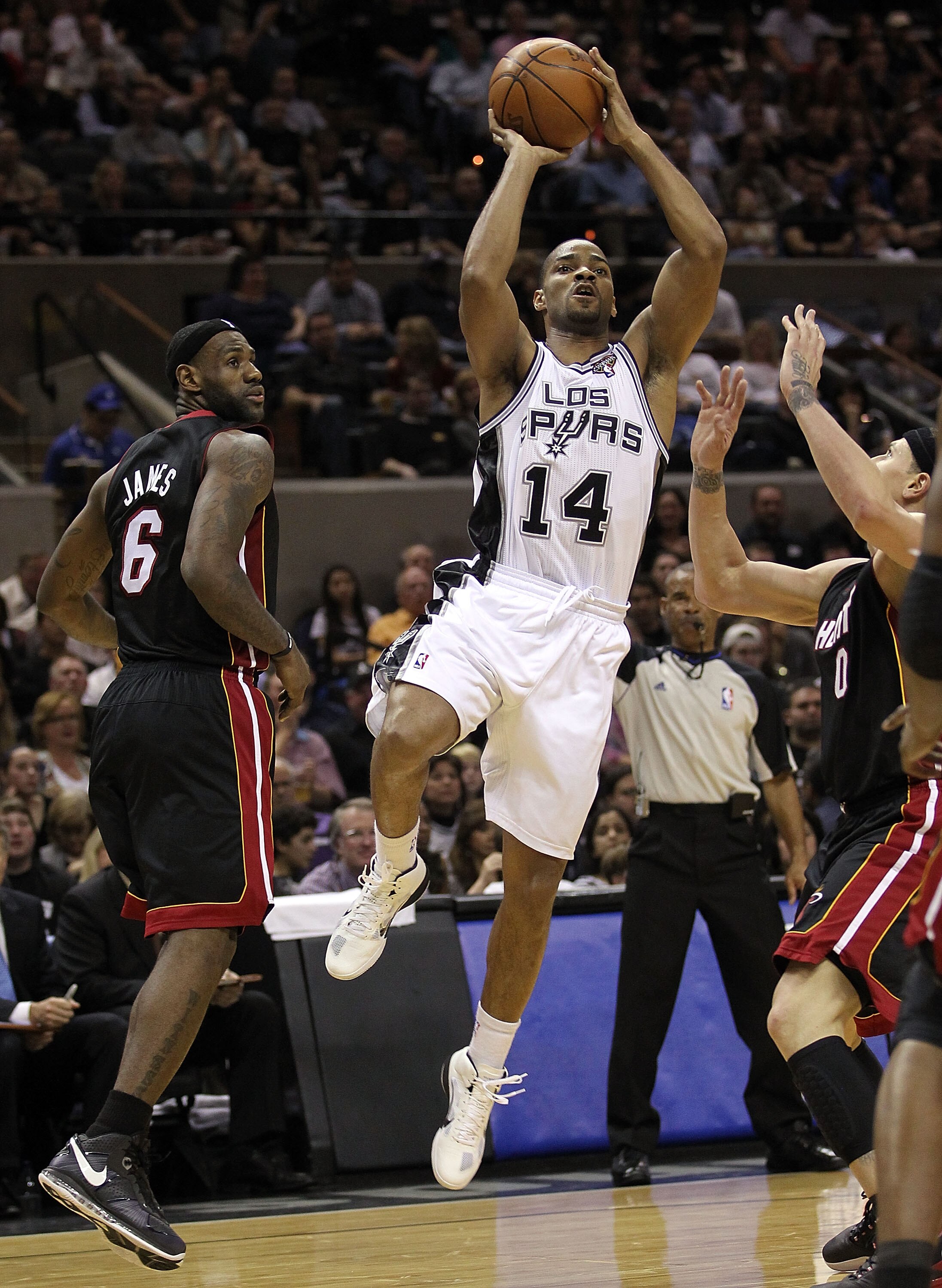 SAN ANTONIO, TX - MARCH 04:  Guard Gary Neal #14 of the San Antonio Spurs takes a shot against LeBron James #6 of the Miami Heat at AT&T Center on March 4, 2011 in San Antonio, Texas.   NOTE TO USER: User expressly acknowledges and agrees that, by downloa