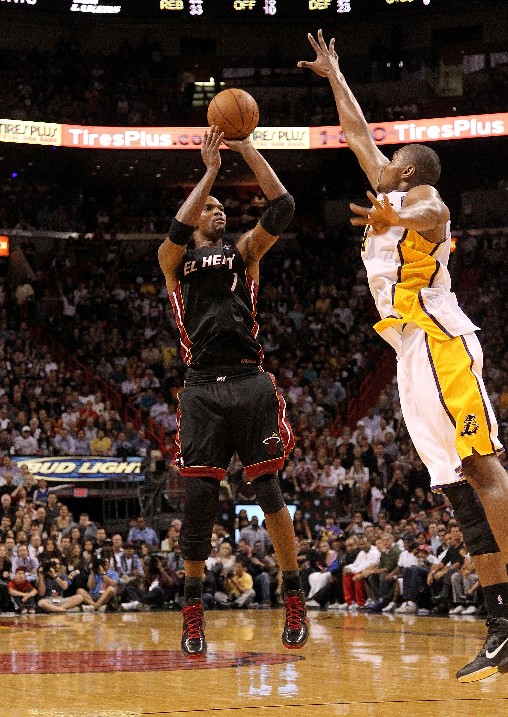 MIAMI, FL - MARCH 10:  Chris Bosh #1 of the Miami Heat shoots over Andrew Bynum #17 of  the Los Angeles Lakers  during a game at American Airlines Arena on March 10, 2011 in Miami, Florida. NOTE TO USER: User expressly acknowledges and agrees that, by dow