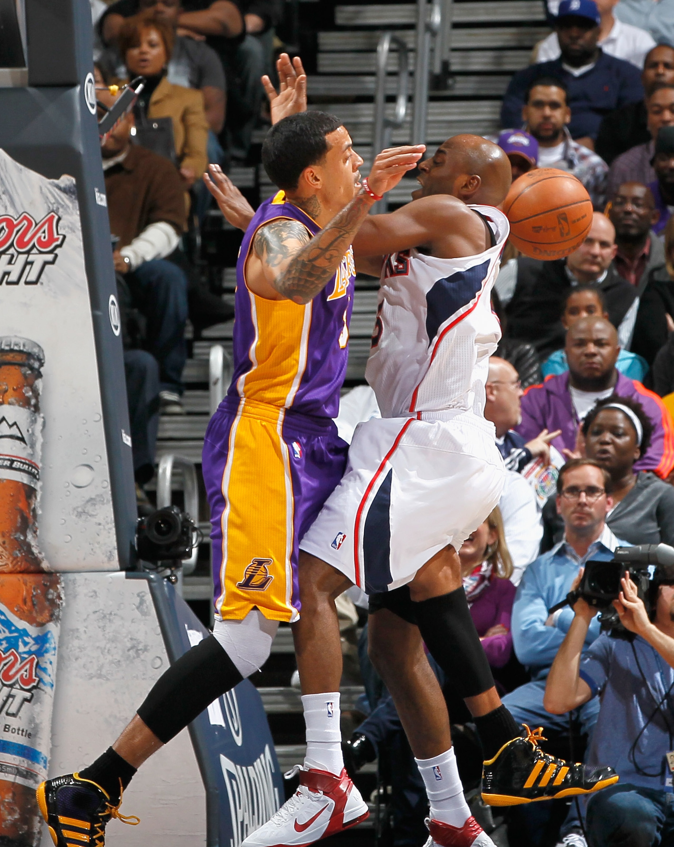 ATLANTA, GA - MARCH 08:  Matt Barnes #9 of the Los Angeles Lakers fouls Damien Wilkins #3 of the Atlanta Hawks at Philips Arena on March 8, 2011 in Atlanta, Georgia.  NOTE TO USER: User expressly acknowledges and agrees that, by downloading and/or using t