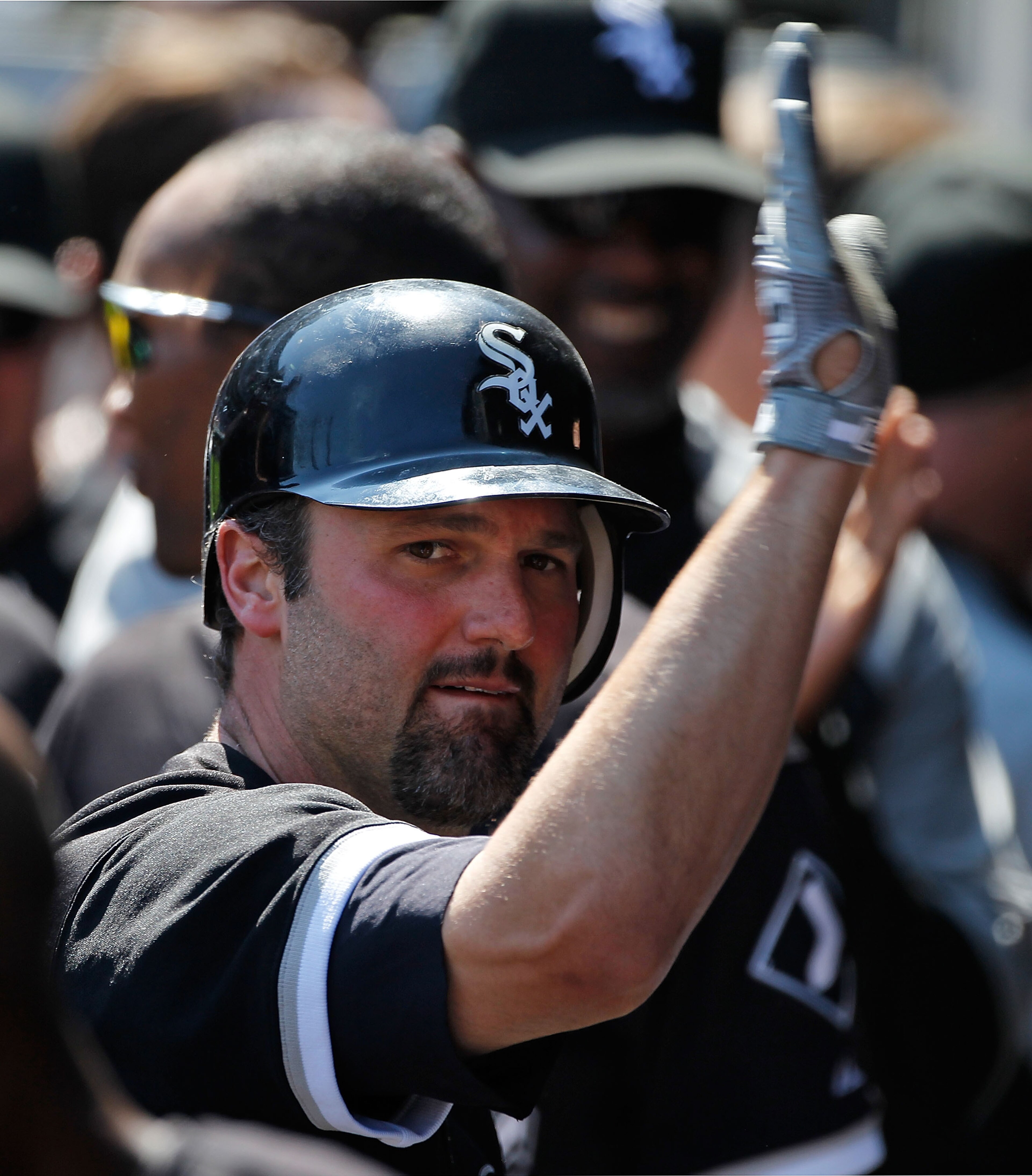 CHICAGO - JUNE 24: Paul Konerko #14 of the Chicago White Sox is greeted by teammates in the dugout after hitting the game winning home run, a two-run shot in the 8th inning, against the Atlanta Braves at U.S. Cellular Field on June 24, 2010 in Chicago, Il