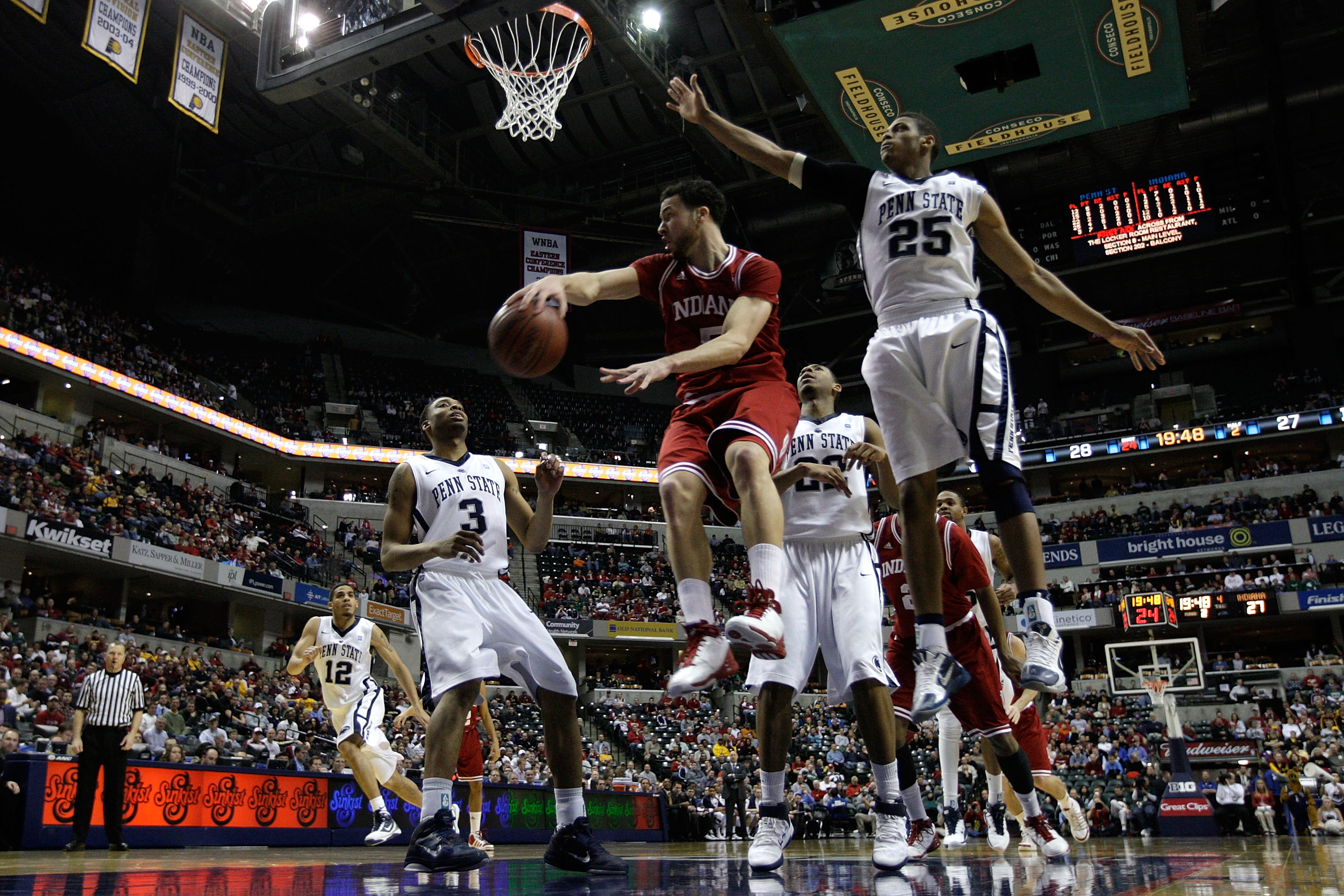 INDIANAPOLIS, IN - MARCH 10: Jeremiah Rivers #5 of the Indiana Hoosiers passes the ball against Jermaine Marshall #3 and Jeff Brooks #25 of the Penn State Nittany Lions during the first round of the 2011 Big Ten Men's Basketball Tournament at Conseco Fie