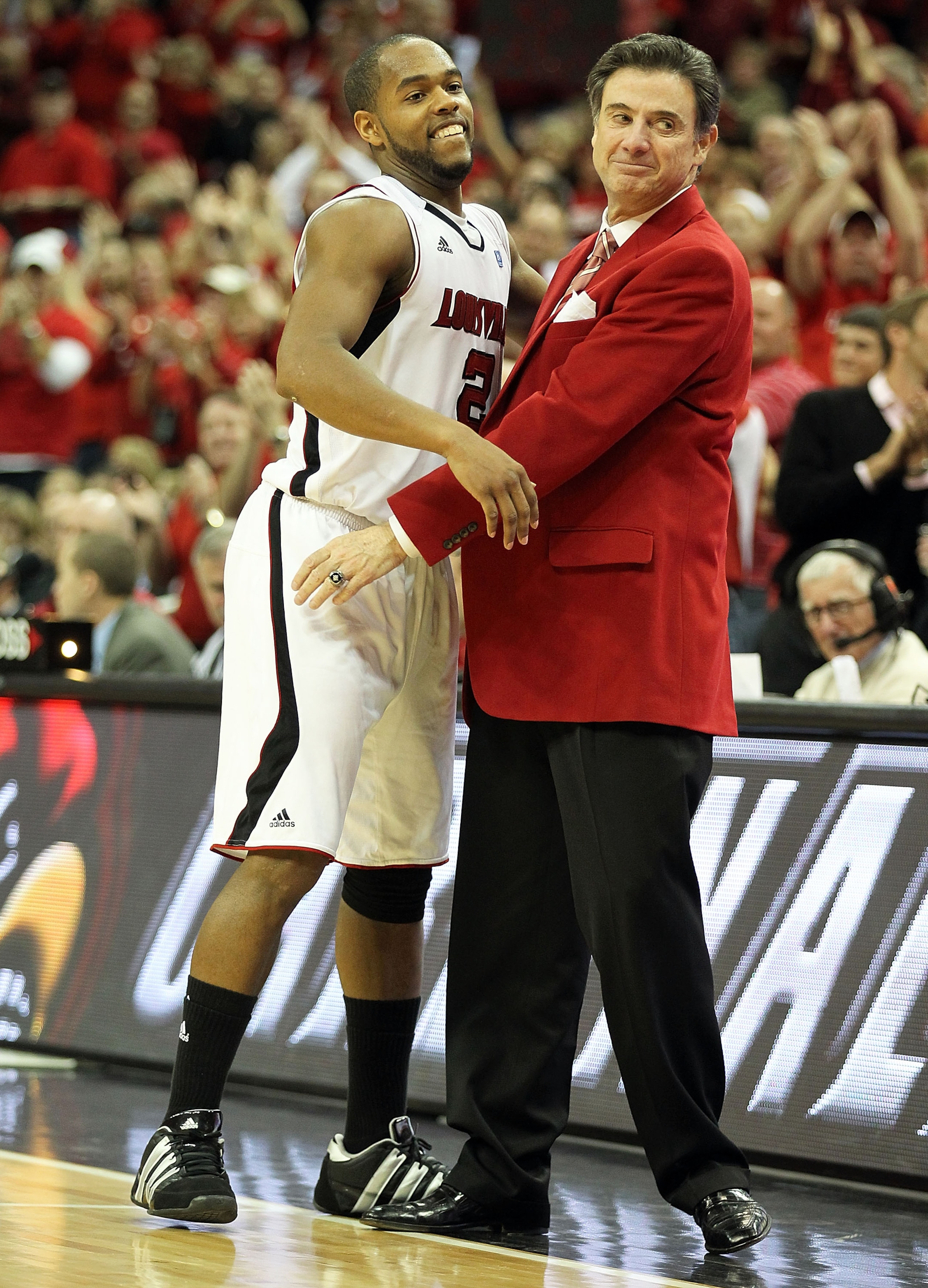 LOUISVILLE, KY - MARCH 02:  Rick Pitino the Head Coach of the Louisville Cardinals hugs Preston Knowles #2 in the final minute of the game during the Big East Conference game against the Providence Friars at the KFC Yum! Center on March 2, 2011 in Louisvi