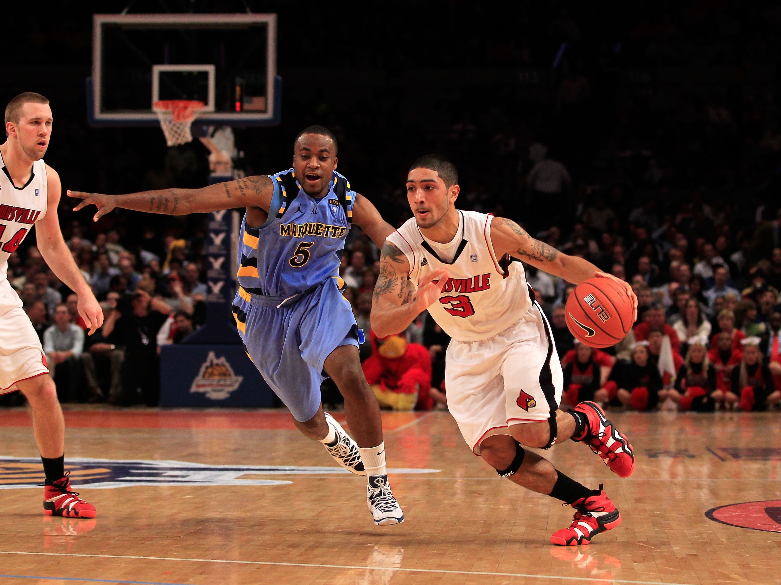 NEW YORK, NY - MARCH 10: Peyton Siva #3 of the Louisville Cardinals brings the ball up court against Junior Cadougan #5 of the Marquette Golden Eagles during the quarterfinals of the 2011 Big East Men's Basketball Tournament presented by American Eagle Ou