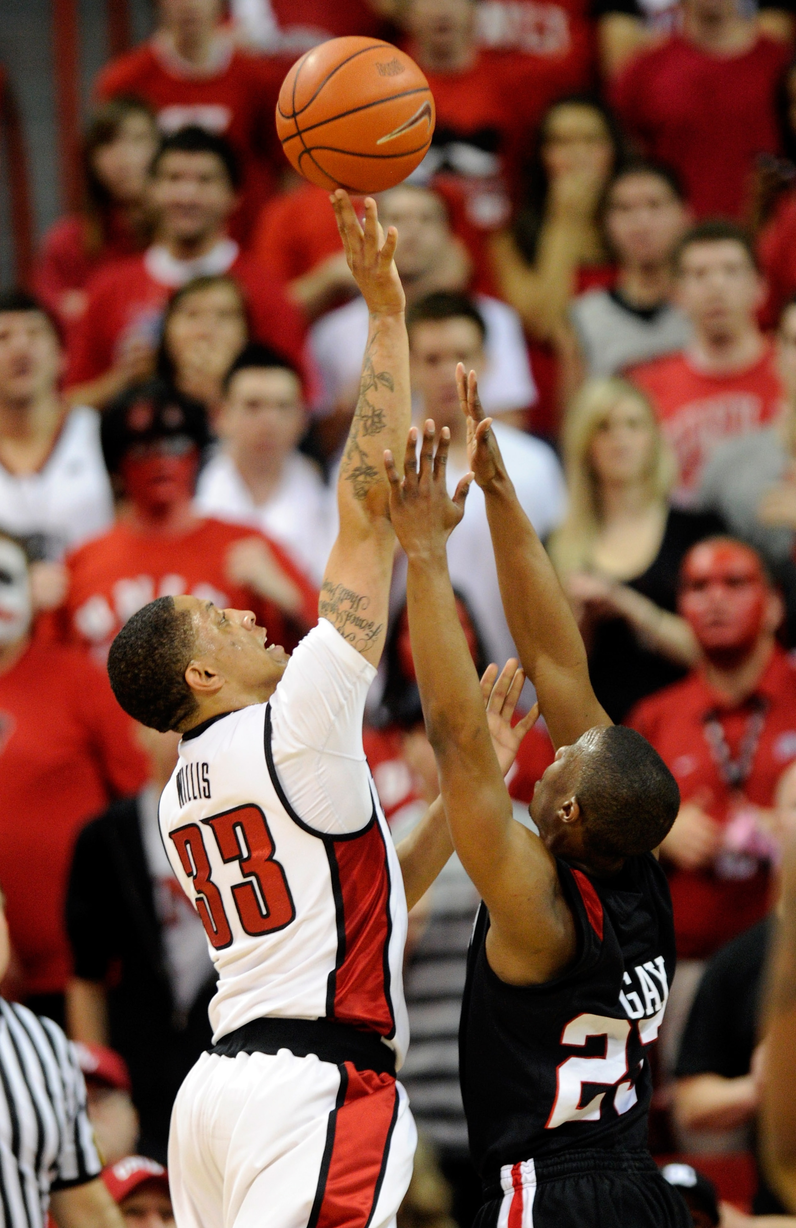 LAS VEGAS, NV - FEBRUARY 12:  Tre'Von Willis #33 of the UNLV Rebels shoots over D.J. Gay #23 of the San Diego State Aztecs during their game at the Thomas & Mack Center February 12, 2011 in Las Vegas, Nevada. San Diego State won 63-57.  (Photo by Ethan Mi