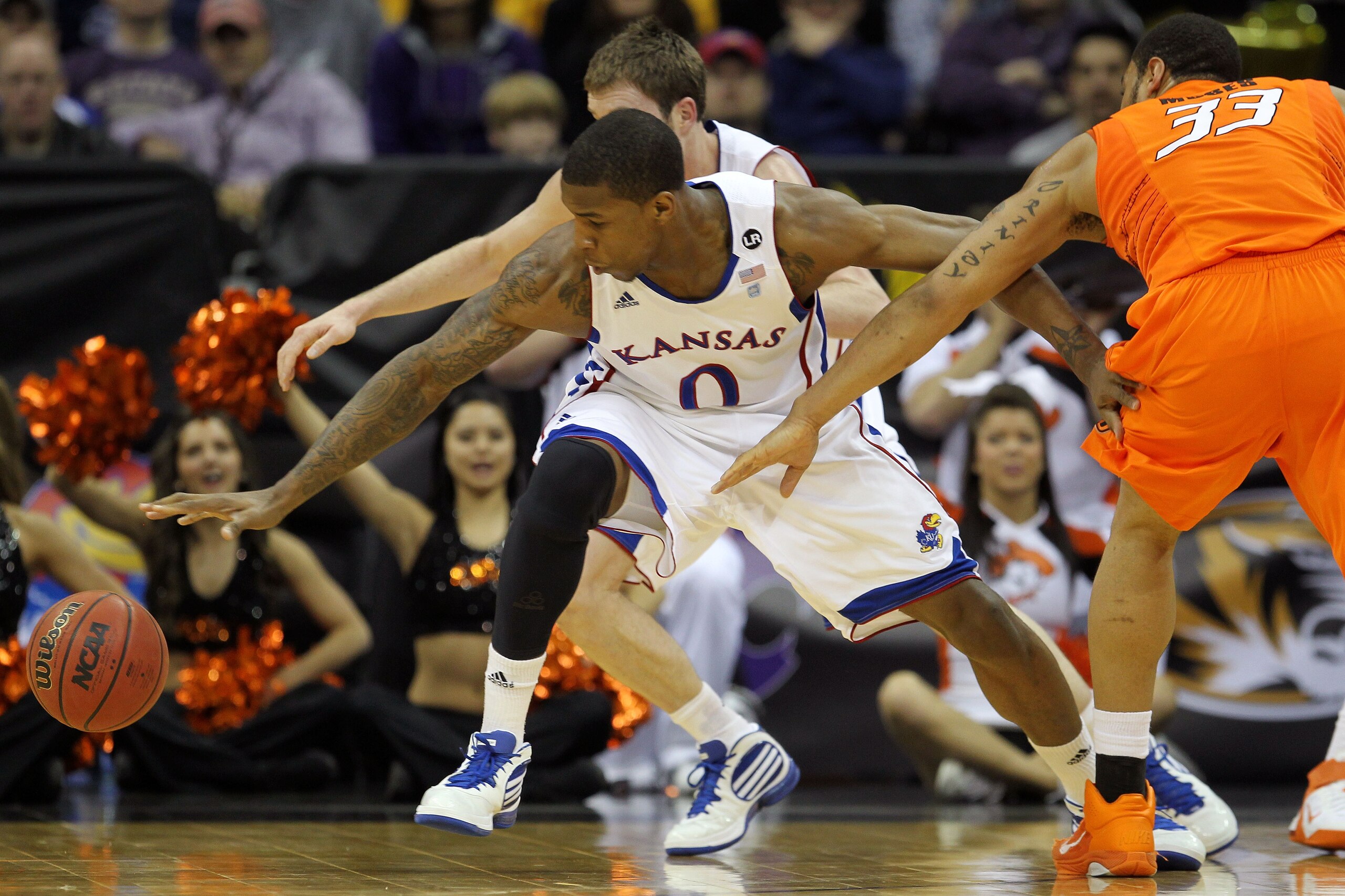 KANSAS CITY, MO - MARCH 10:  Thomas Robinson #0 of the Kansas Jayhawks goes after a loose ball against the Oklahoma State Cowboys during their quarterfinal game in the 2011 Phillips 66 Big 12 Men's Basketball Tournament at Sprint Center on March 10, 2011