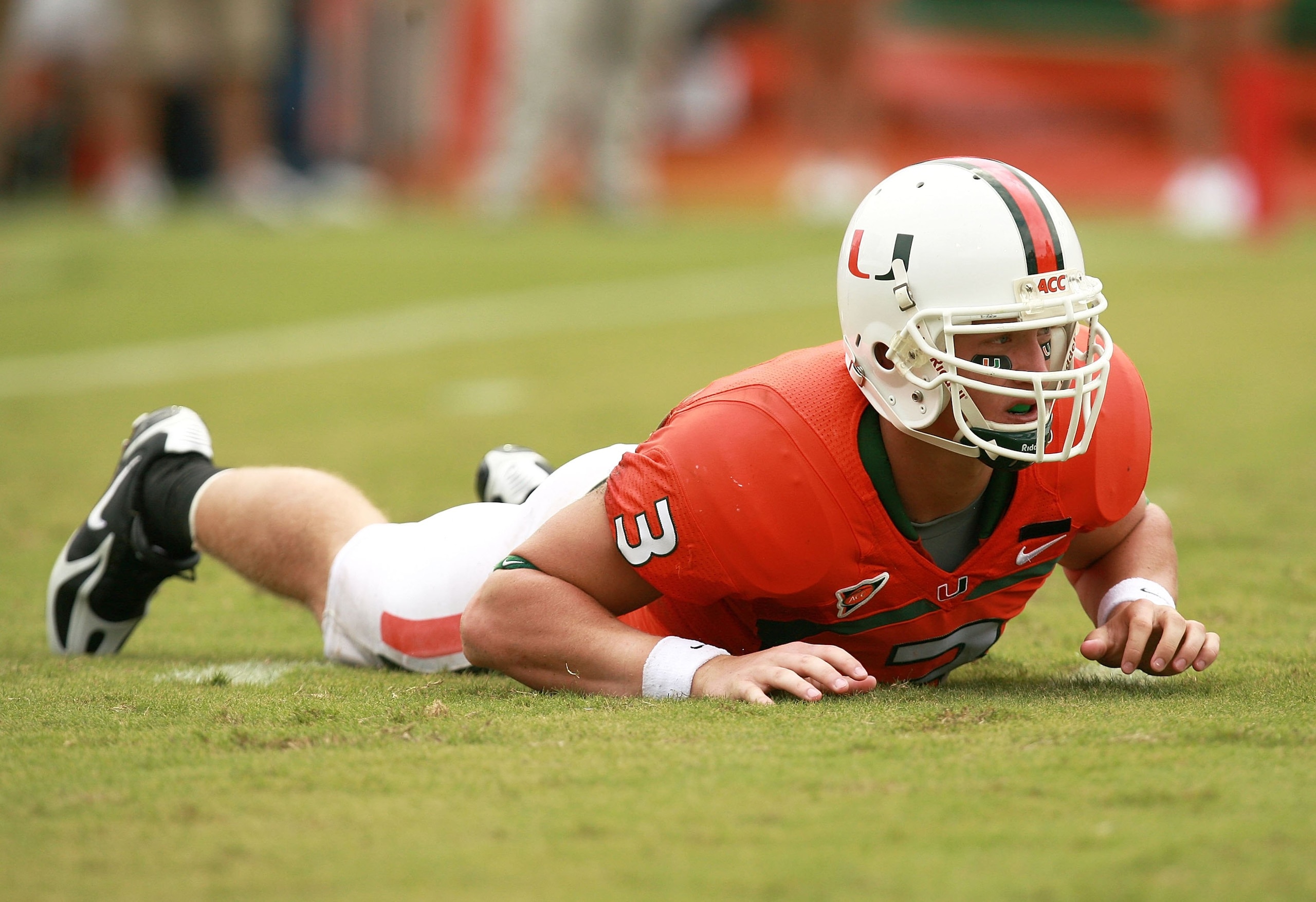CORAL GABLES, FL - OCTOBER 13:  Quarterback Kyle Wright #3 of the Miami Hurricanes is slow to get up after being hit while throwing a pass against the Georgia Tech Yellow Jackets at the Orange Bowl on October 13, 2007 in Coral Gables, Florida. Georgia Tec