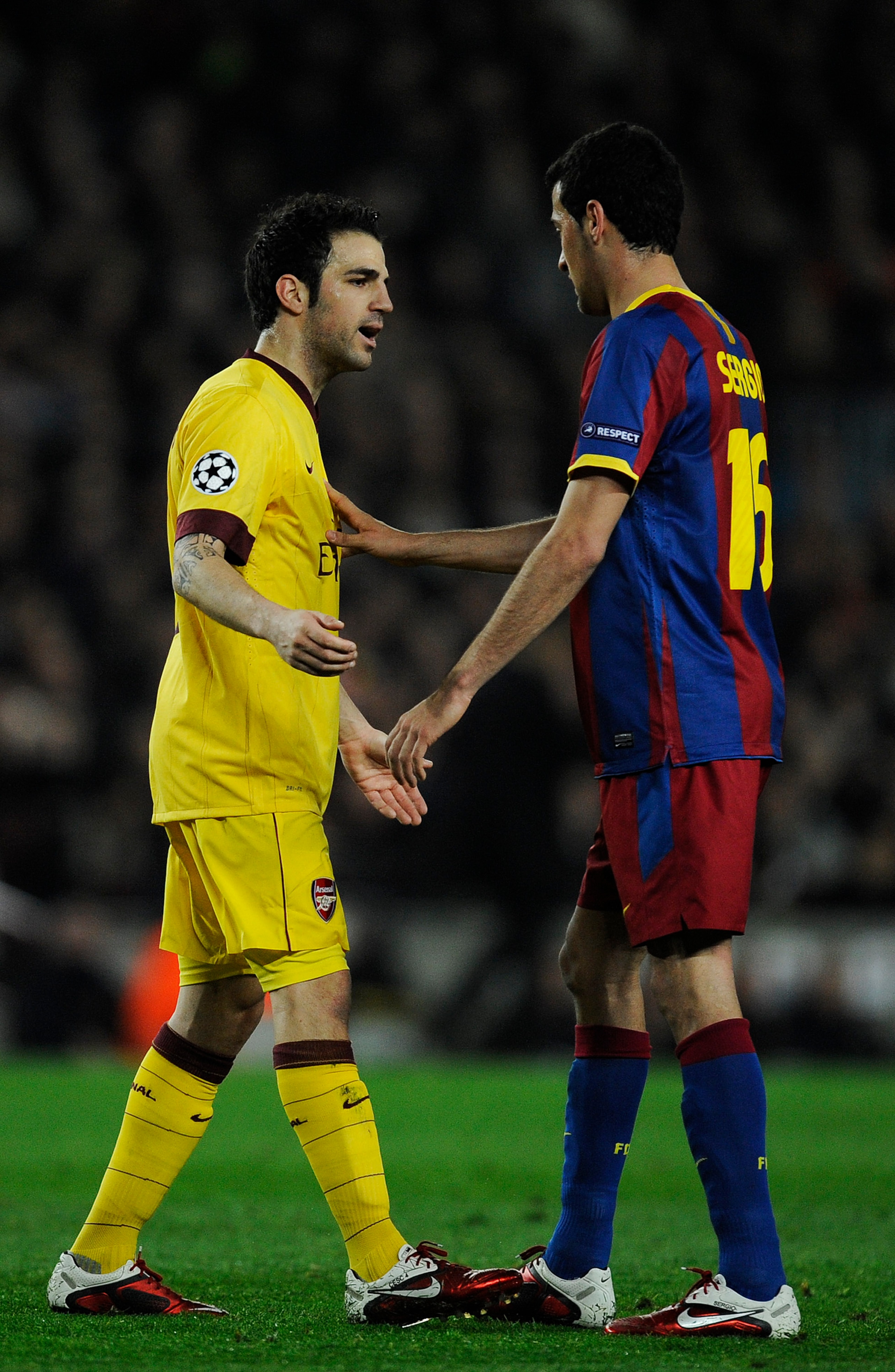 BARCELONA, SPAIN - MARCH 08:  Cesc Fabregas of Arsenal (L) argues with Sergio Busquets of FC Barcelona during the UEFA Champions League round of 16 second leg match between Barcelona and Arsenal at the Camp Nou stadium on March 8, 2011 in Barcelona, Spain