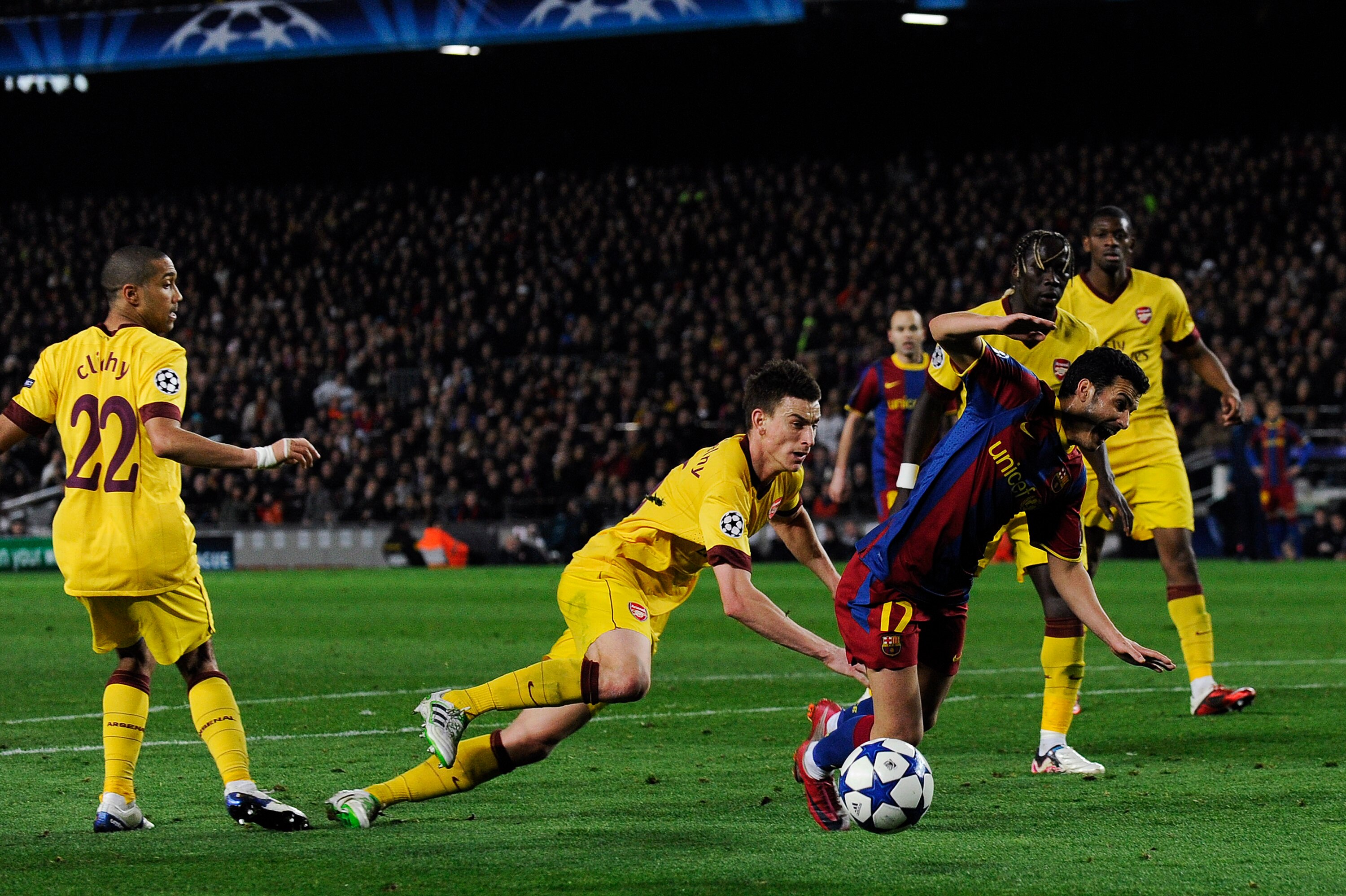 BARCELONA, SPAIN - MARCH 08:  Laurent Koscielny of Arsenal brings down Pedro Rodriguez of FC Barcelona to concede a penalty during the UEFA Champions League round of 16 second leg match between Barcelona and Arsenal at the Camp Nou stadium on March 8, 201