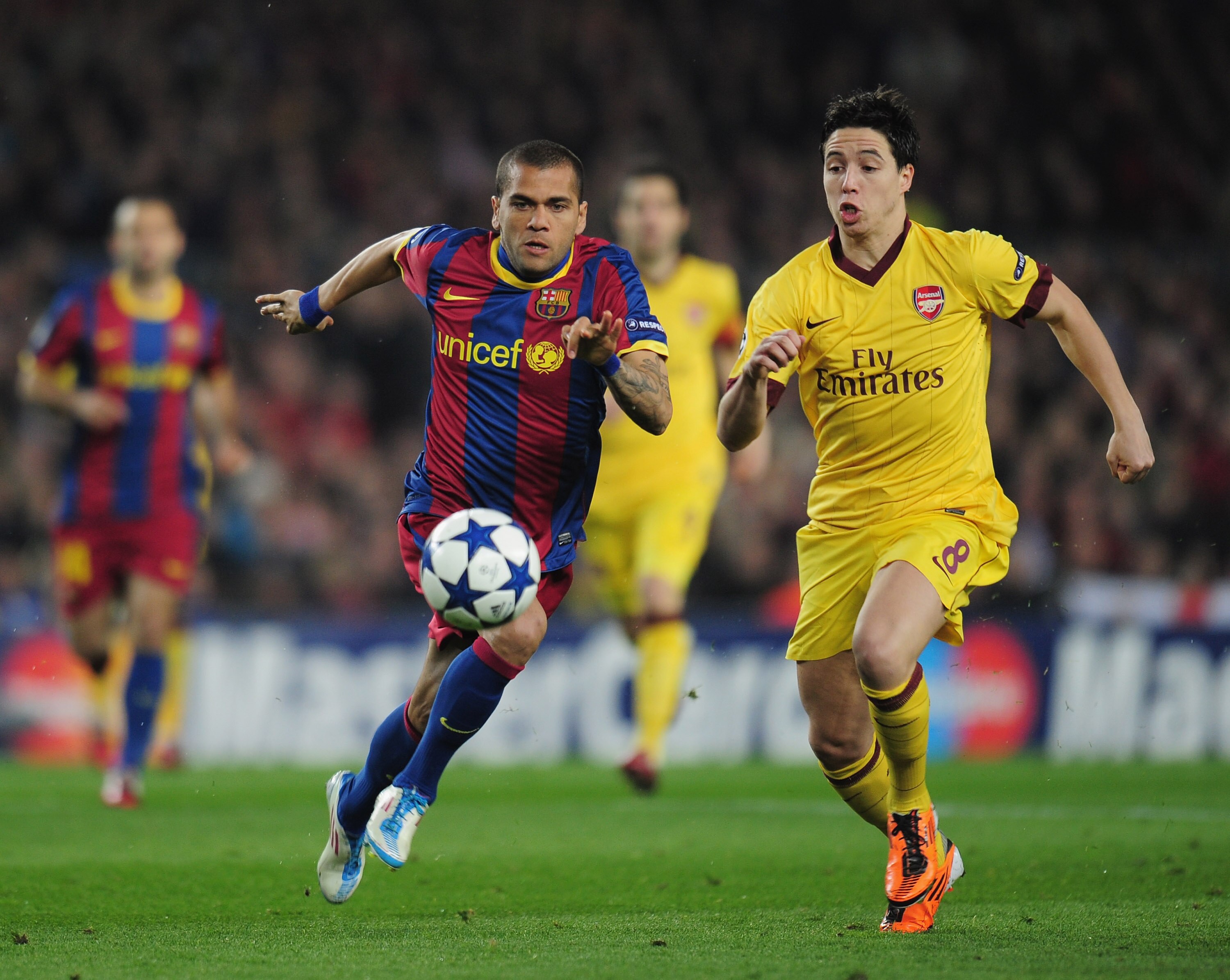 BARCELONA, SPAIN - MARCH 08:  Daniel Alves of Barcelona is challenged by Samir Nasri of Arsenal during the UEFA Champions League round of 16 second leg match between Barcelona and Arsenal at the Nou Camp Stadium on March 8, 2011 in Barcelona, Spain.  (Pho