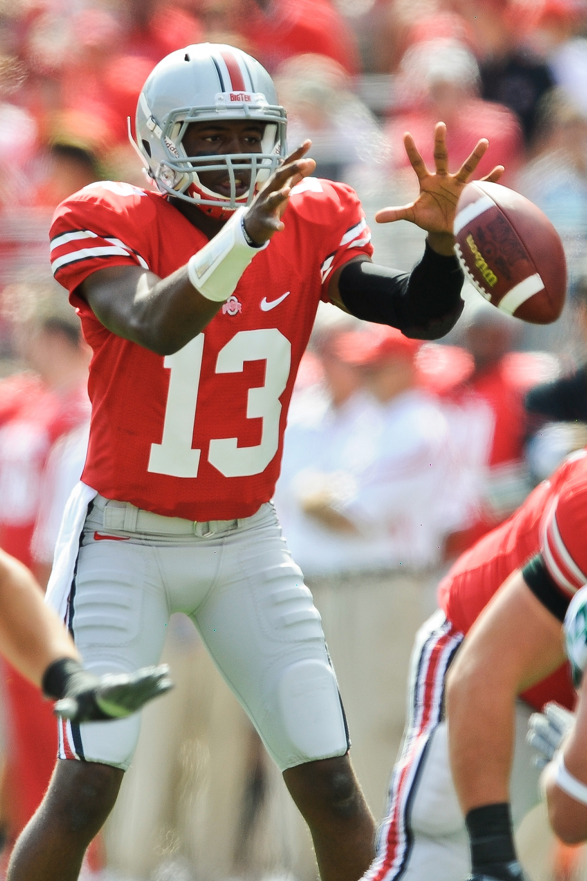 COLUMBUS, OH - SEPTEMBER 18:  Quarterback Ken Guiton #13 of the Ohio State Buckeyes takes the snap against the Ohio Bobcats at Ohio Stadium on September 18, 2010 in Columbus, Ohio.  (Photo by Jamie Sabau/Getty Images)
