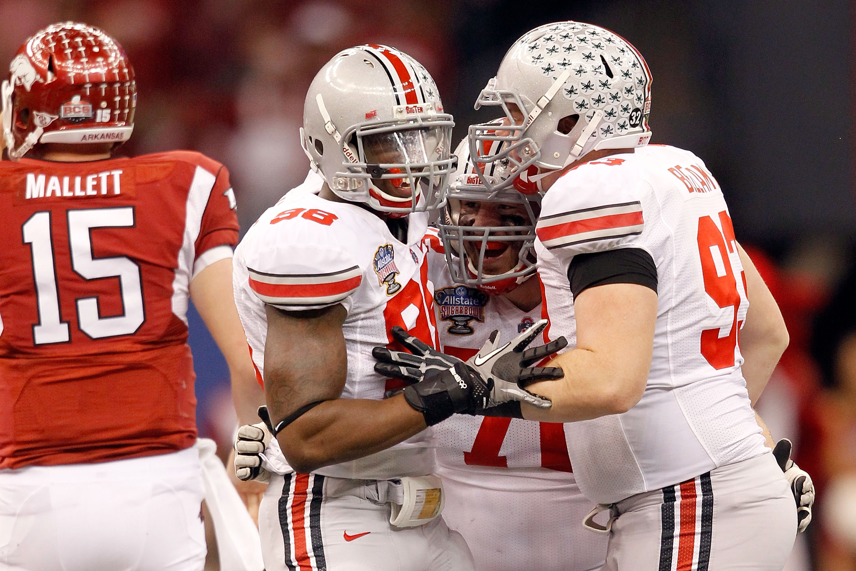 NEW ORLEANS, LA - JANUARY 04:  Dexter Larimore #72 of the Ohio State Buckeyes celebrates with teammates Solomon Thomas #98 and Adam Bellamy #93  after Larimore sacks Ryan Mallett #15 of the Arkansas Razorbacks in the second quarter during the Allstate Sug