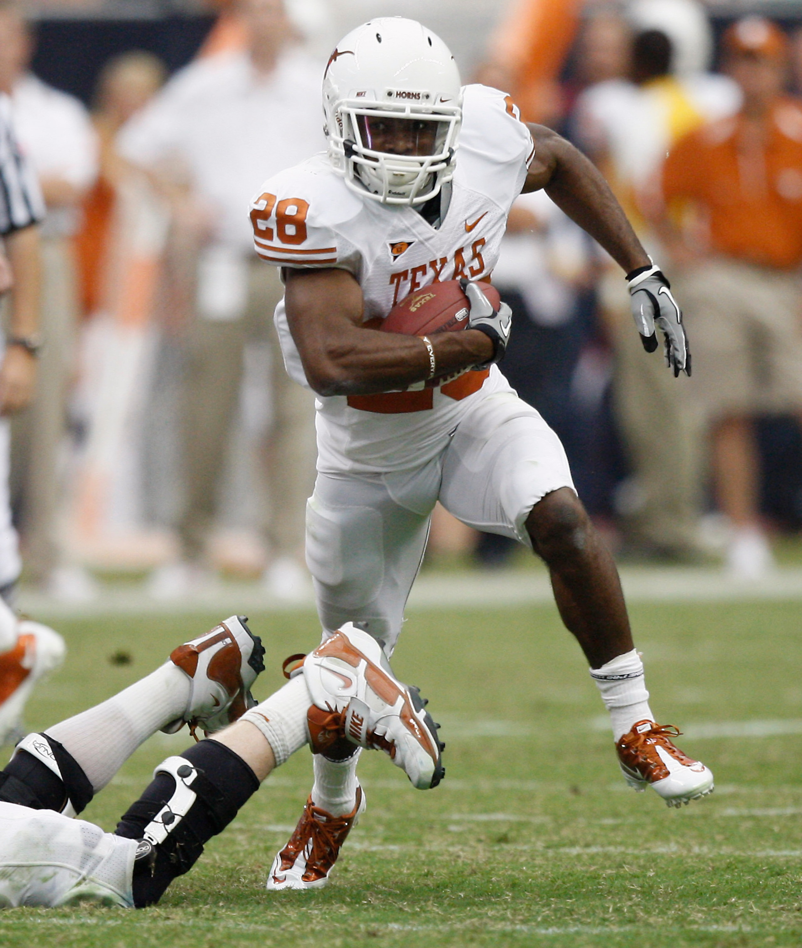 HOUSTON - SEPTEMBER 04:  Running back Fozzy Whitaker #28 of the Texas Longhorns rushes against the Rice Owls at Reliant Stadium on September 4, 2010 in Houston, Texas.  (Photo by Bob Levey/Getty Images)
