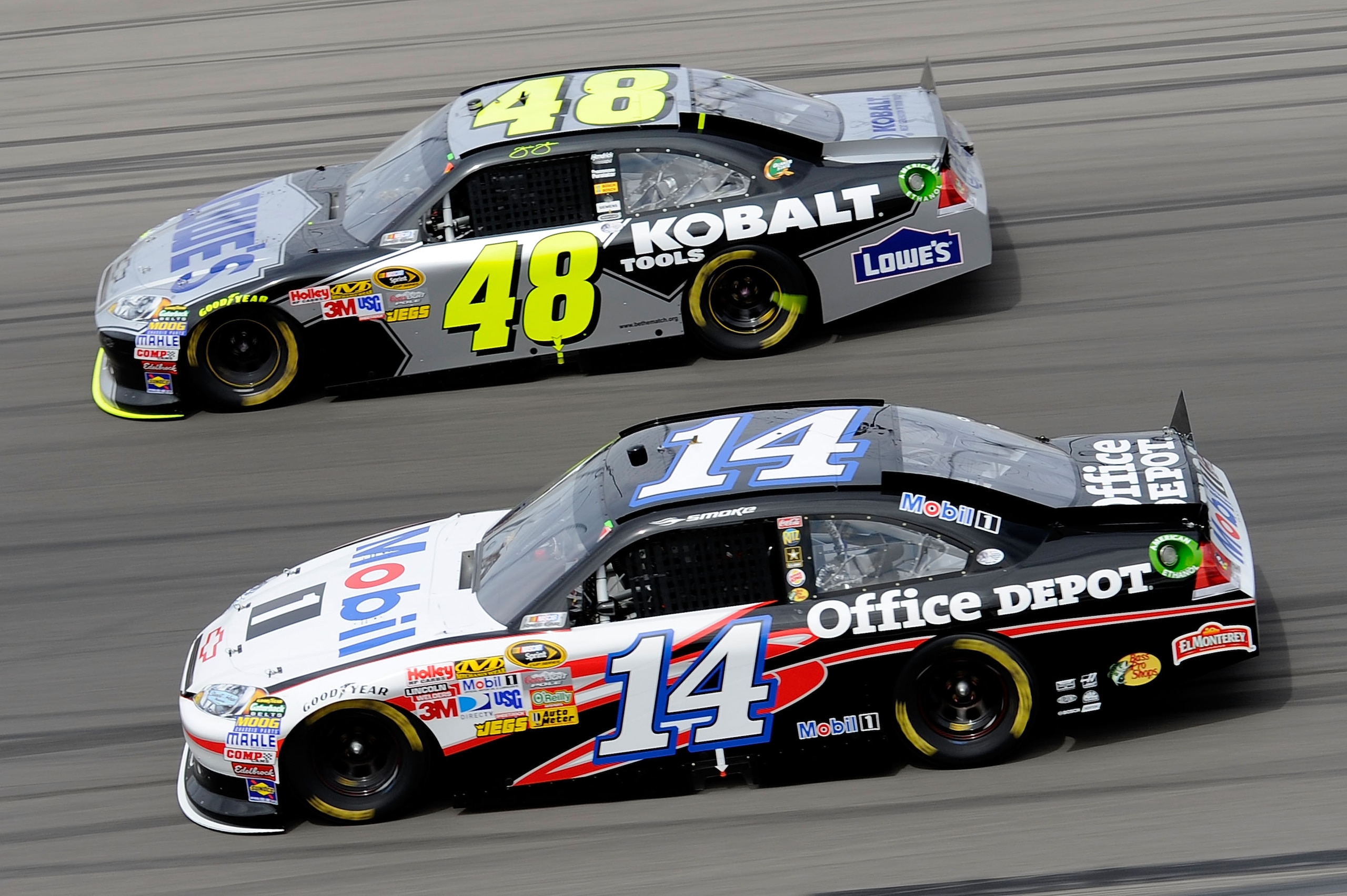 LAS VEGAS, NV - MARCH 06:  Jimmie Johnson, driver of the #48 Lowe's/Kobalt Tools Chevrolet, races Tony Stewart, driver of the #14 Mobil 1/Office Depot Chevrolet, during the NASCAR Sprint Cup Series Kobalt Tools 400 at Las Vegas Motor Speedway on March 6,