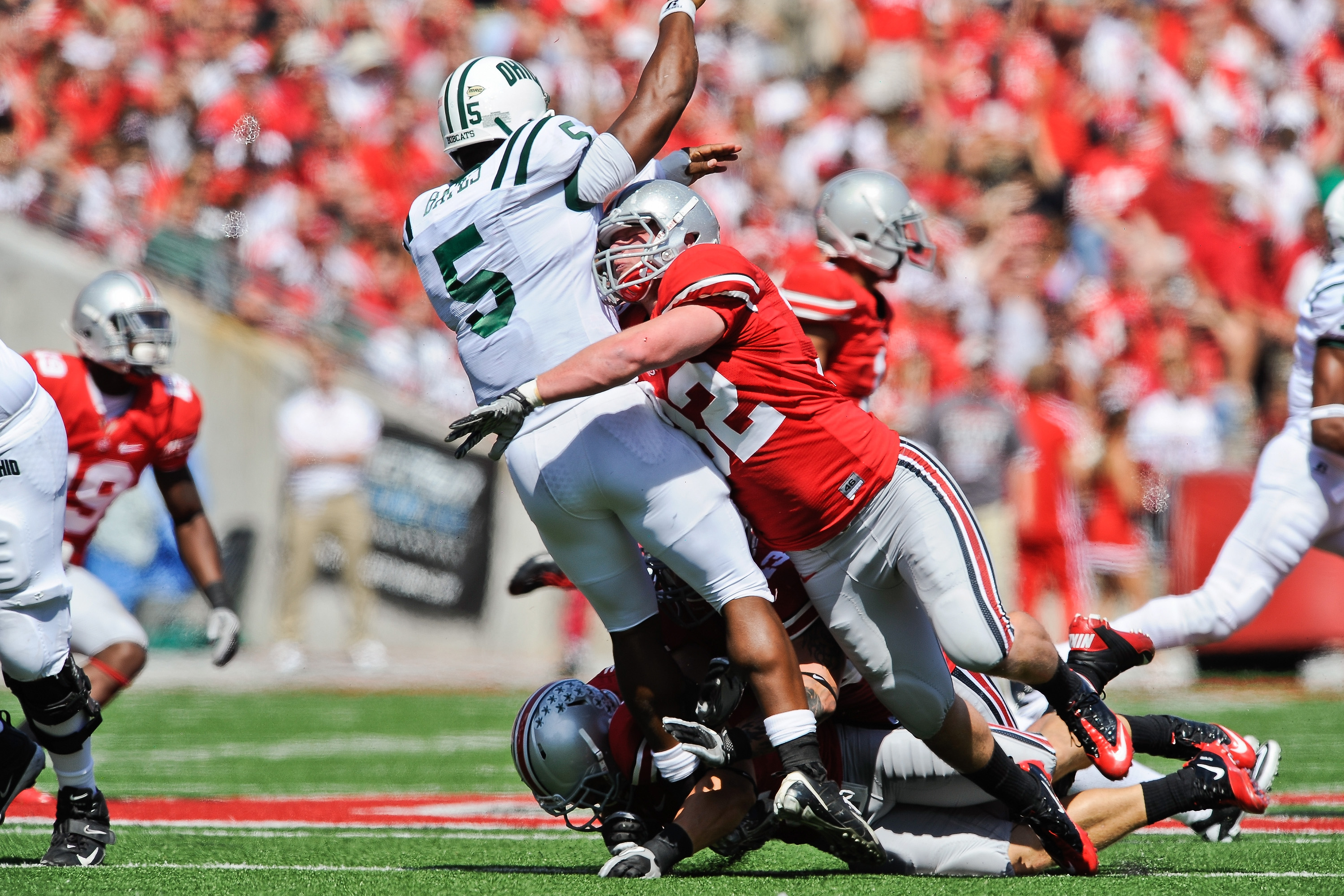 COLUMBUS, OH - SEPTEMBER 18:  Storm Klein #32 of the Ohio State Buckeyes hits quarterback Phil Bates #5 of the Ohio Bobcats right after Bates releases the ball at Ohio Stadium on September 18, 2010 in Columbus, Ohio.  (Photo by Jamie Sabau/Getty Images)
