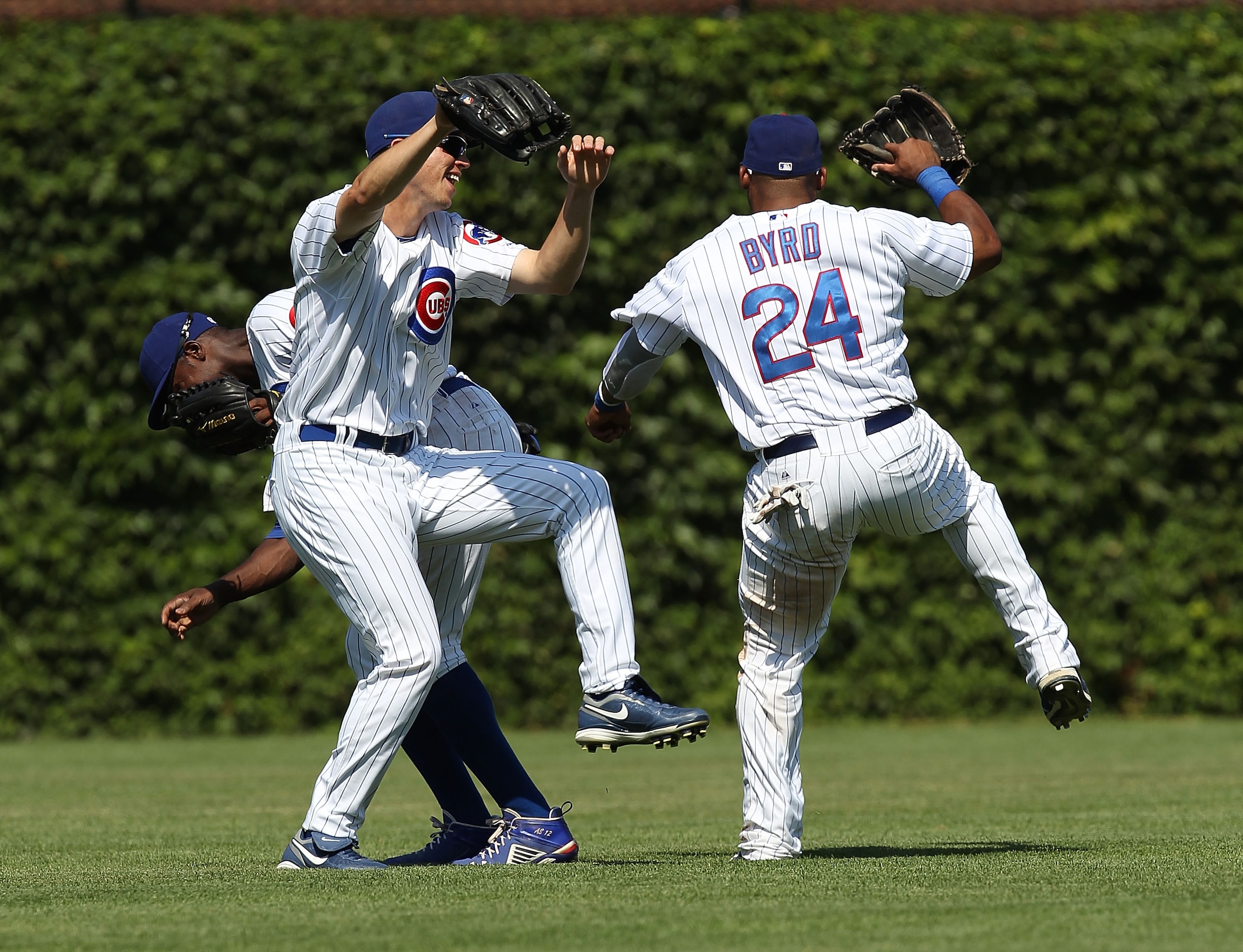 CHICAGO - JULY 16: (L-R) Alfonso Soriano #12, Tyler Colvin #21 and Marlon Byrd #24 of the Chicago Cubs celebrate a win over the Philadelphia Phillies at Wrigley Field on July 16, 2010 in Chicago, Illinois. The Cubs defeated the Phillies 4-3. (Photo by Jon