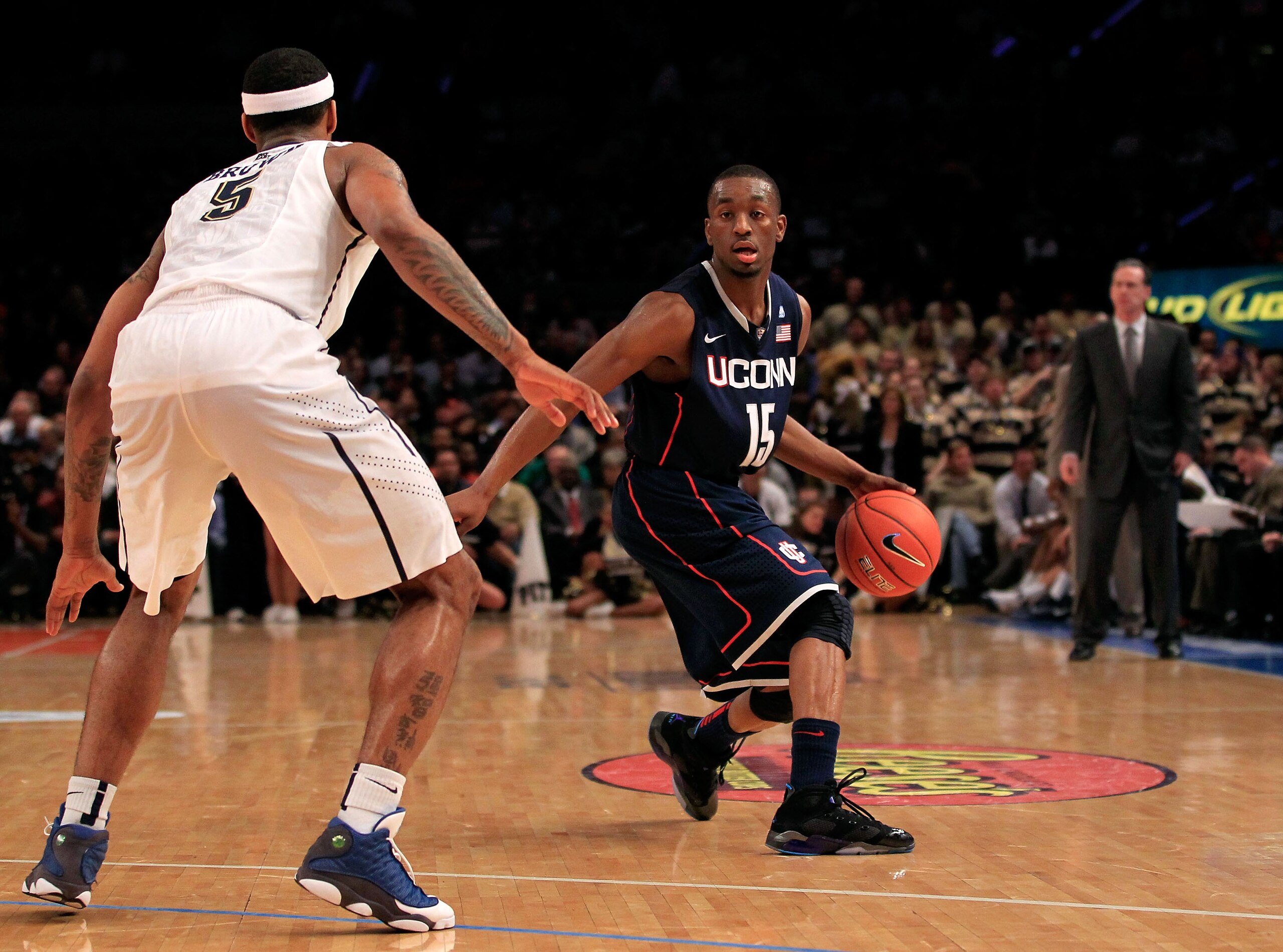 NEW YORK, NY - MARCH 10: Kemba Walker #15 of the Connecticut Huskies dribbles the ball against Gilbert Brown #5 of the Pittsburgh Panthers during the quarterfinals of the 2011 Big East Men's Basketball Tournament presented by American Eagle Outfitters  at