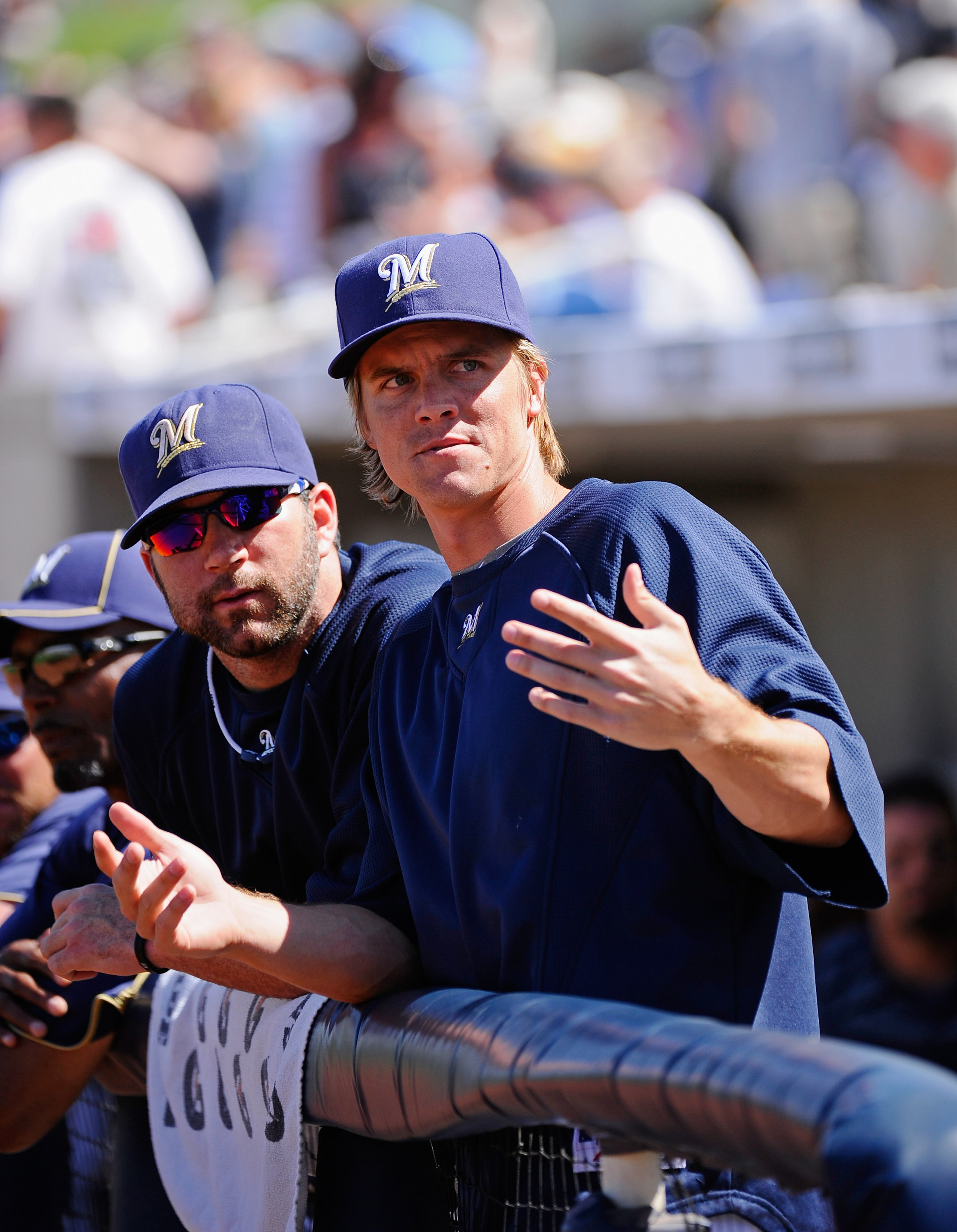 PHOENIX, AZ - MARCH 10:  Pitchers Zack Greinke #13 and Shaun Marcum #18  of the Milwaukee Brewers look at fans during the spring teaining baseball agme against Colorado Rockies at Maryvale Baseball Park on March 10, 2011 in Phoenix, Arizona.  (Photo by Ke