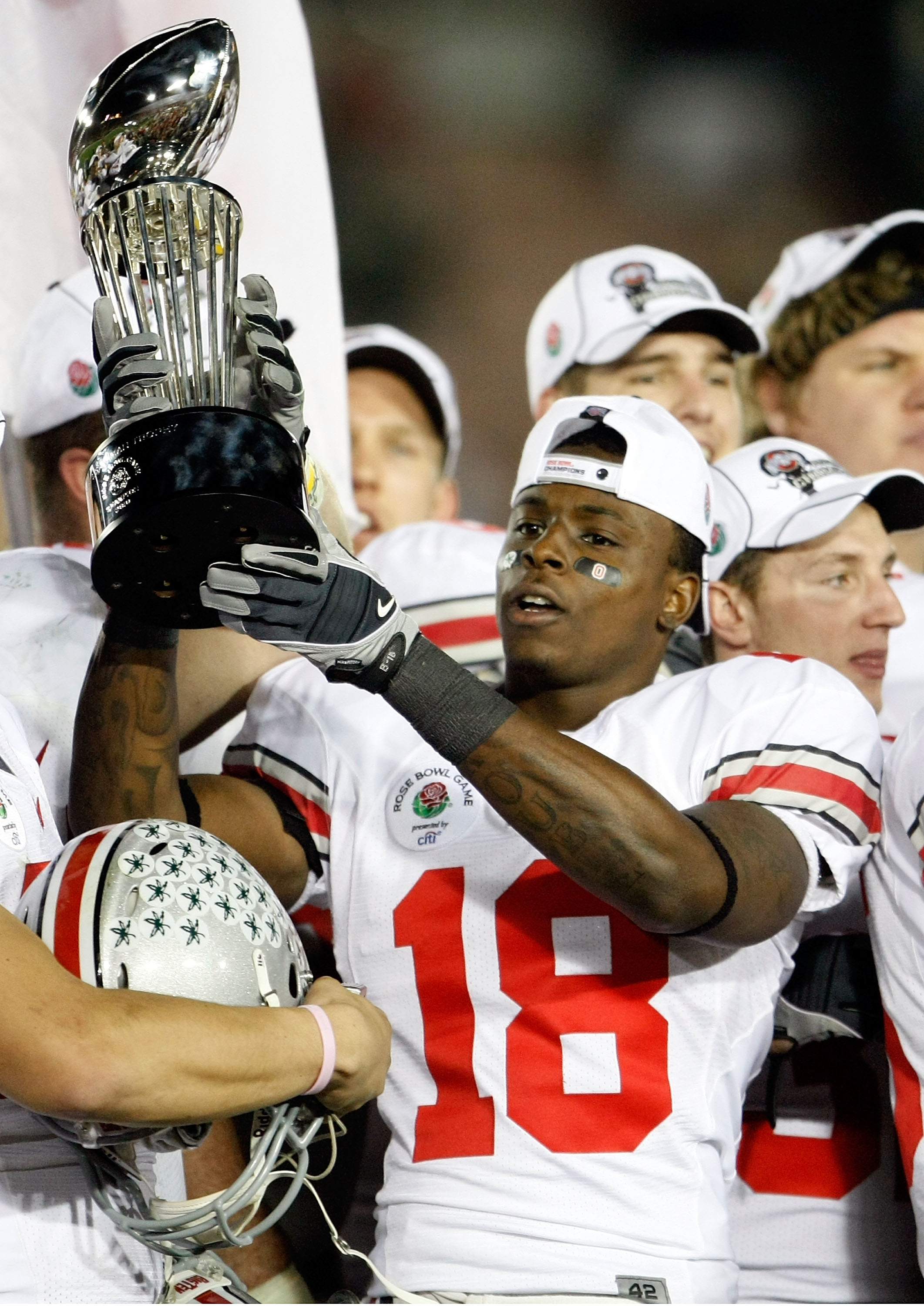 PASADENA, CA - JANUARY 01:  Cornerback Travis Howard #18 of the Ohio State Buckeyes celebrates with the Rose Bowl championship trophy after the Buckeyes 26-17 win over the Oregon Ducks in the 96th Rose Bowl game on January 1, 2010 in Pasadena, California.
