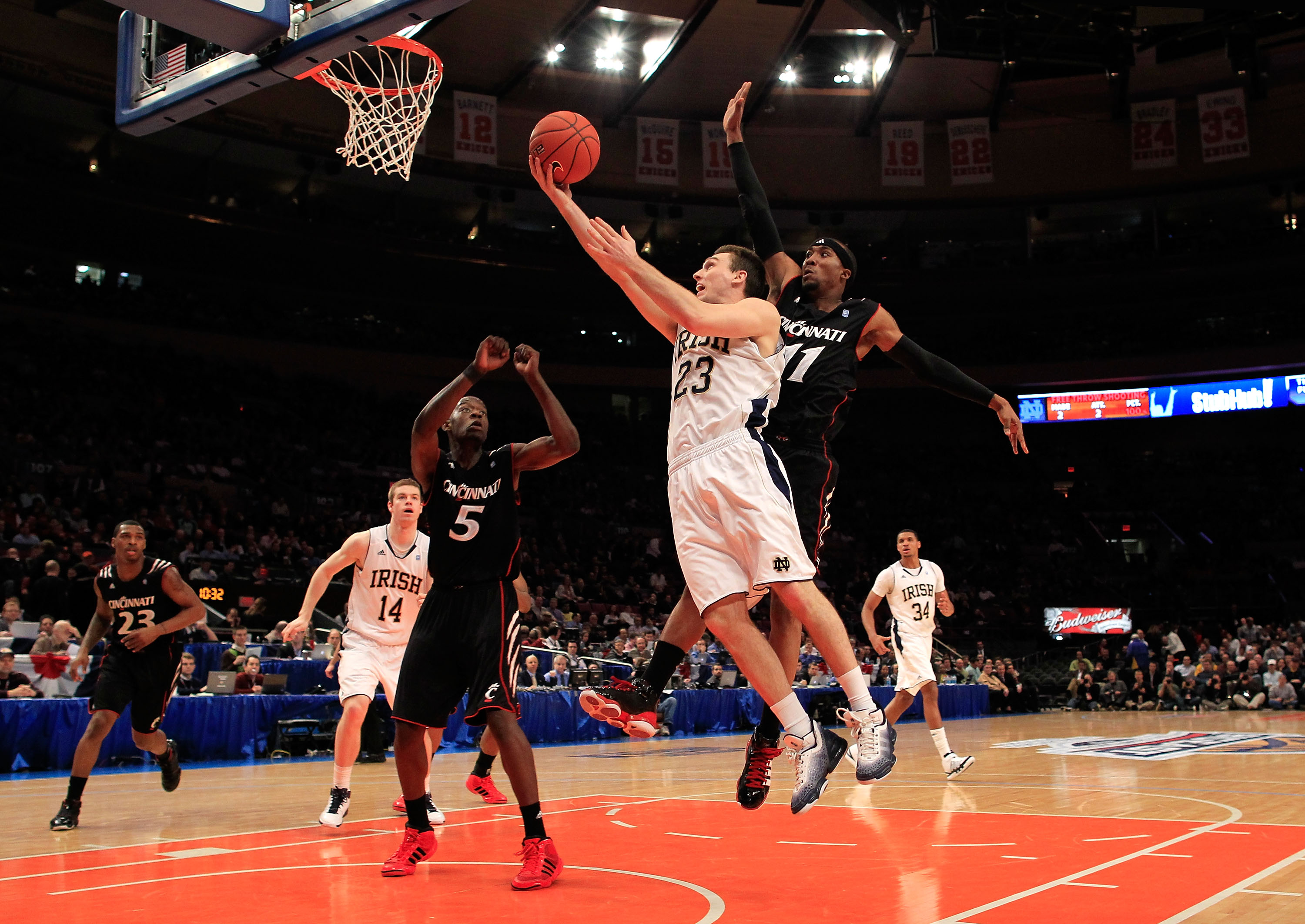 NEW YORK, NY - MARCH 10: Ben Hansbrough #23 of the Notre Dame Fighting Irish drives to the basket against Justin Jackson #5 against the Notre Dame Fighting Irish Larry Davis #11 of the Cincinnati Bearcats during the quarterfinals of the 2011 Big East Men