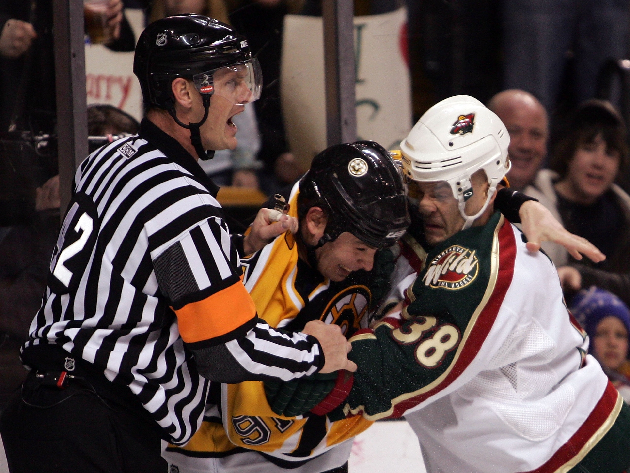 BOSTON - MARCH 8:  Referee Dan O'Rourke #42 tries to break up a fight between Pavol Demitra #38 of the Minnesota Wild and Marc Savard #91 of the Boston Bruins on March 8, 2007 at the TD Banknorth Garden in Boston, Massachusetts. (Photo by Elsa/Getty Image