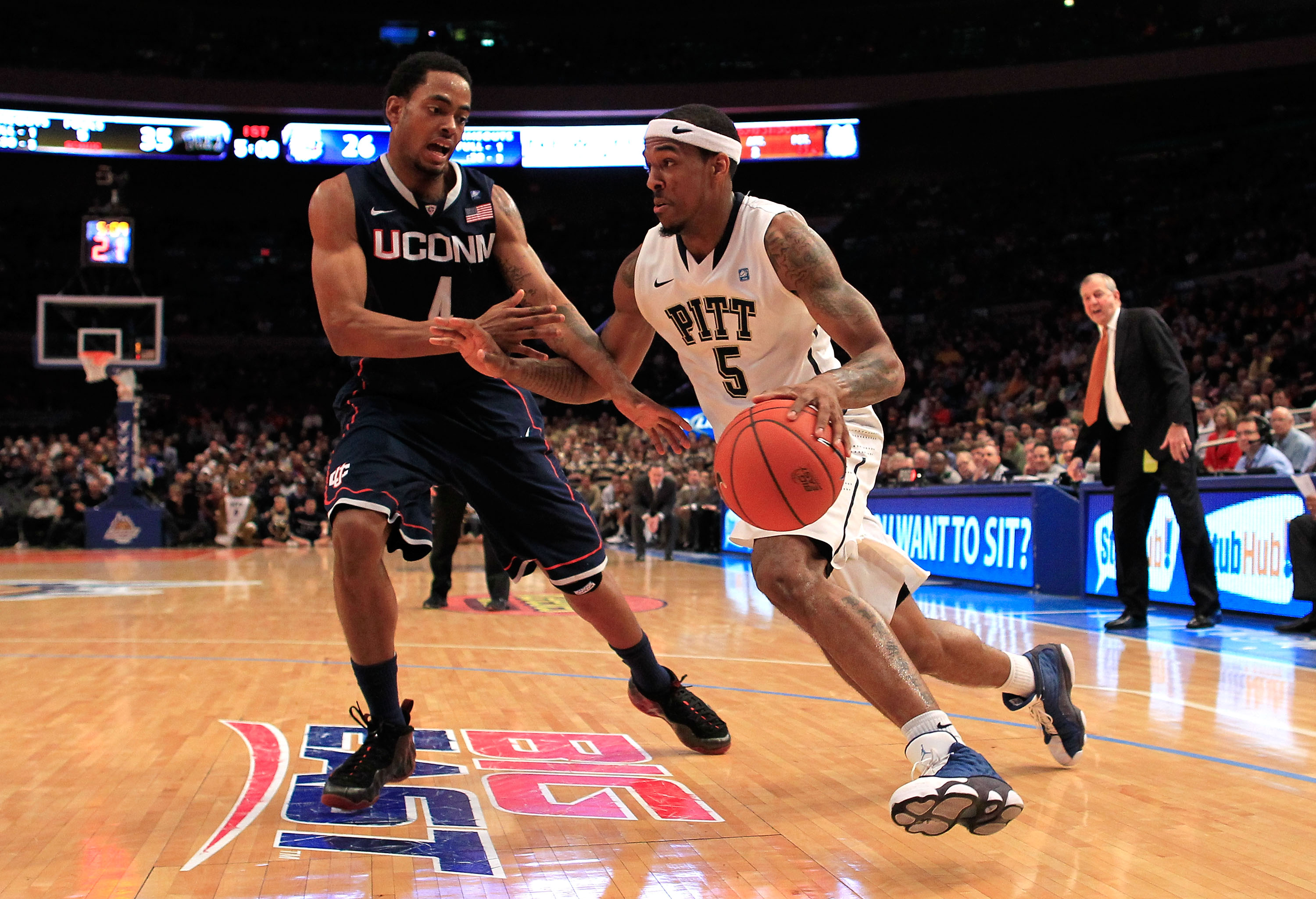 NEW YORK, NY - MARCH 10: Gilbert Brown #5 of the Pittsburgh Panthers dribbles past Jamal Coombs-McDaniel #4 of the Connecticut Huskies during the quarterfinals of the 2011 Big East Men's Basketball Tournament presented by American Eagle Outfitters at Mad