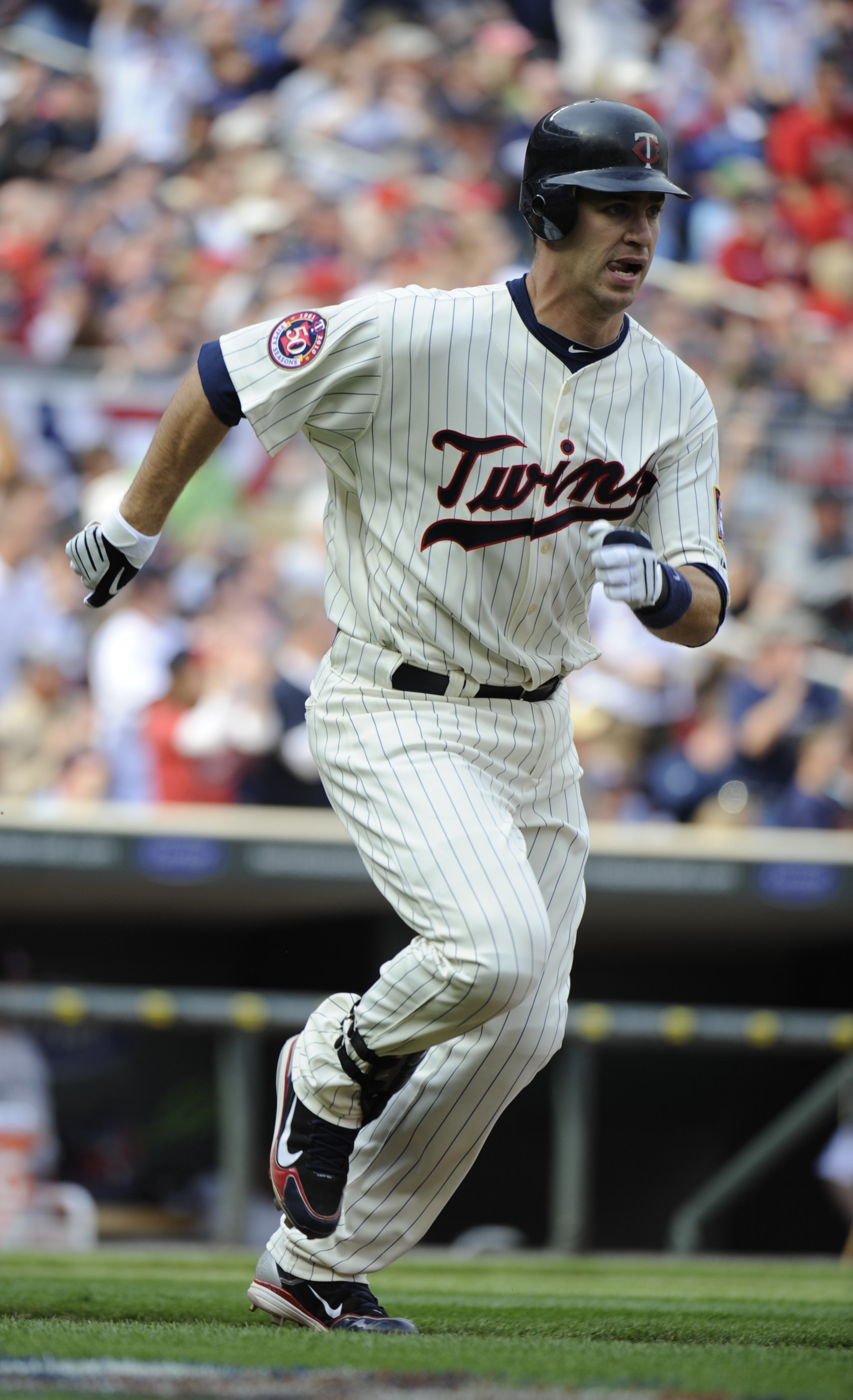 MINNEAPOLIS, MN - APRIL 12: Joe Mauer #7 of the Minnesota Twins runs towards first base after hitting an RBI double in the second inning against the Boston Red Sox during the Twins home opener at Target Field on April 12, 2010 in Minneapolis, Minnesota. ( MINNEAPOLIS, MN - APRIL 12: Joe Mauer #7 of the Minnesota Twins runs towards first base after hitting an RBI double in the second inning against the Boston Red Sox during the Twins home opener at Target Field on April 12, 2010 in Minneapolis, Minnesota. (