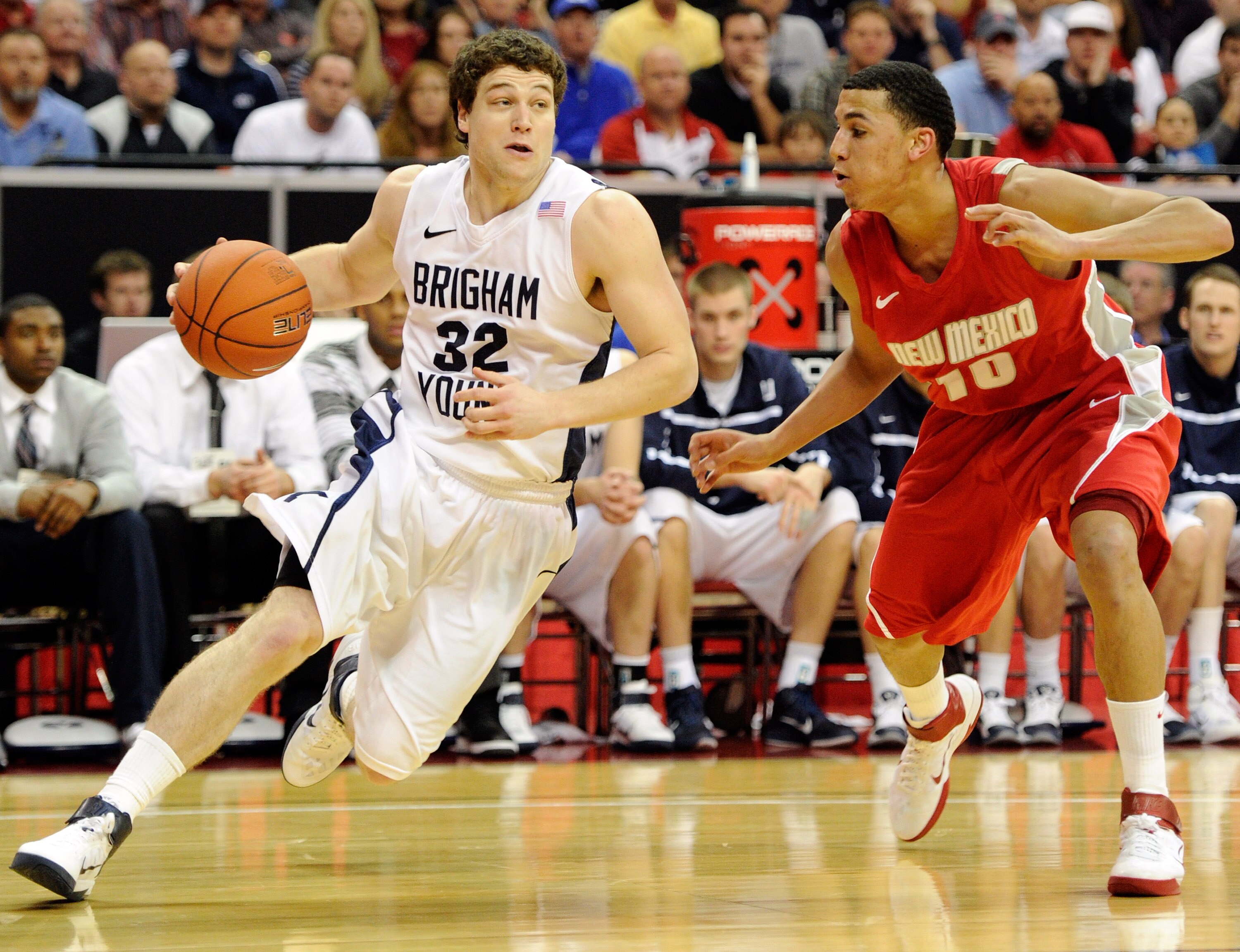 LAS VEGAS, NV - MARCH 11:  Jimmer Fredette #32 of the Brigham Young University Cougars drives against Kendall Williams #10 of the New Mexico Lobos during a semifinal game of the Conoco Mountain West Conference Basketball tournament at the Thomas & Mack Ce