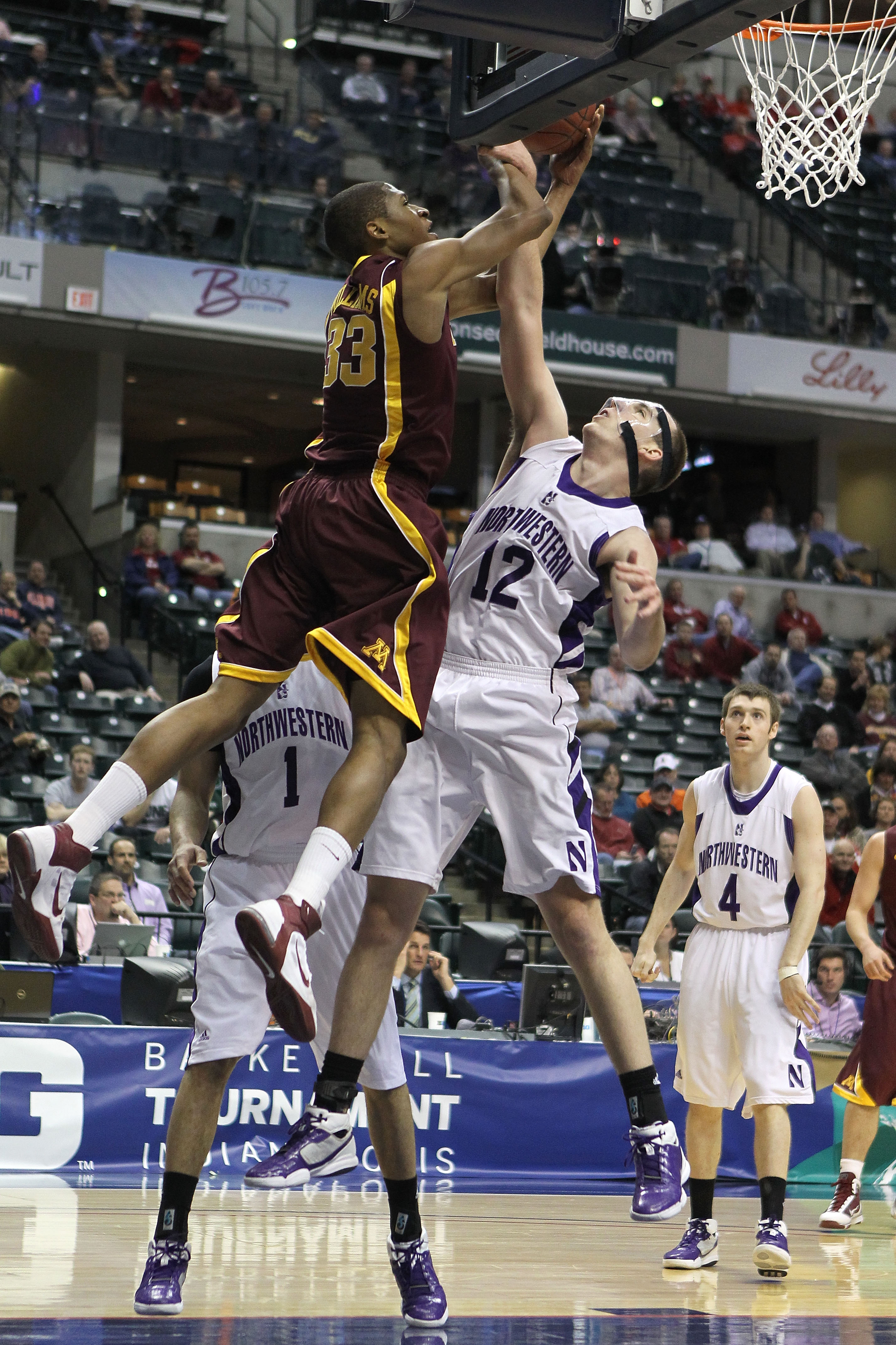 INDIANAPOLIS, IN - MARCH 10: Rodney Williams #33 of the Minnesota Golden Gophers goes up for a shot attempt against Luka Mirkovic #12 of the Northwestern Wildcats during the first round of the 2011 Big Ten Men's Basketball Tournament at Conseco Fieldhous