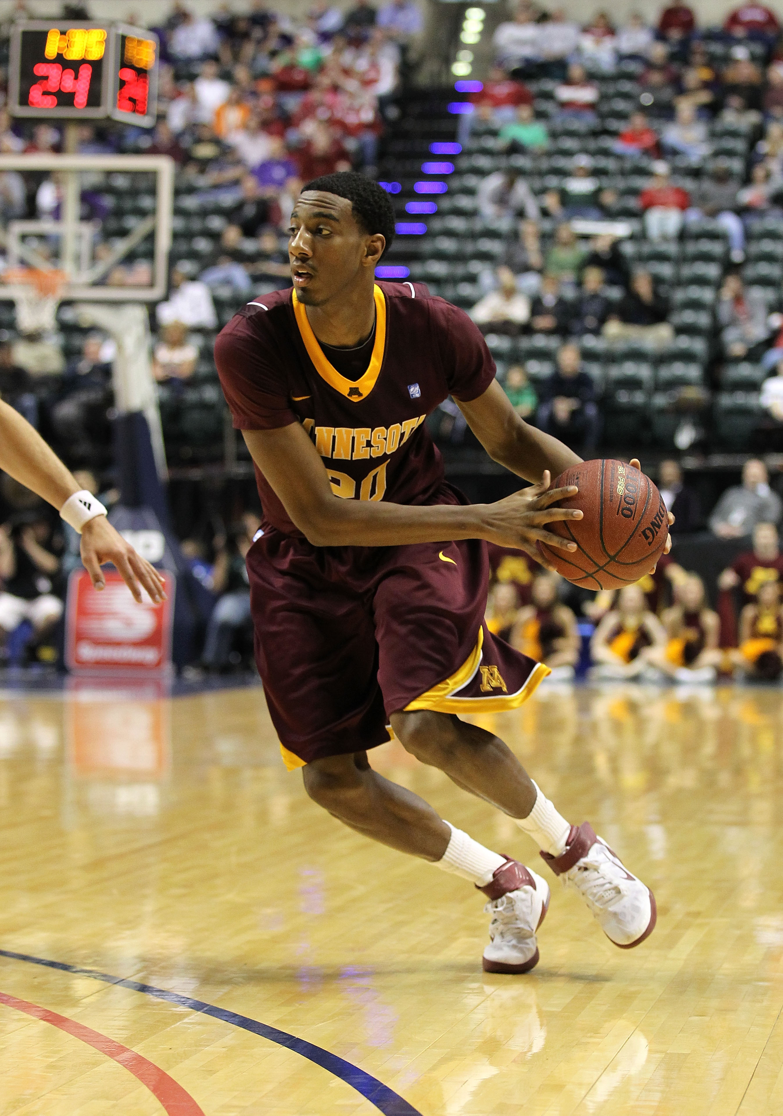 INDIANAPOLIS, IN - MARCH 10: Austin Hollins #20 of the Minnesota Golden Gophers drives against the Northwestern Wildcats during the first round of the 2011 Big Ten Men's Basketball Tournament at Conseco Fieldhouse on March 10, 2011 in Indianapolis, India
