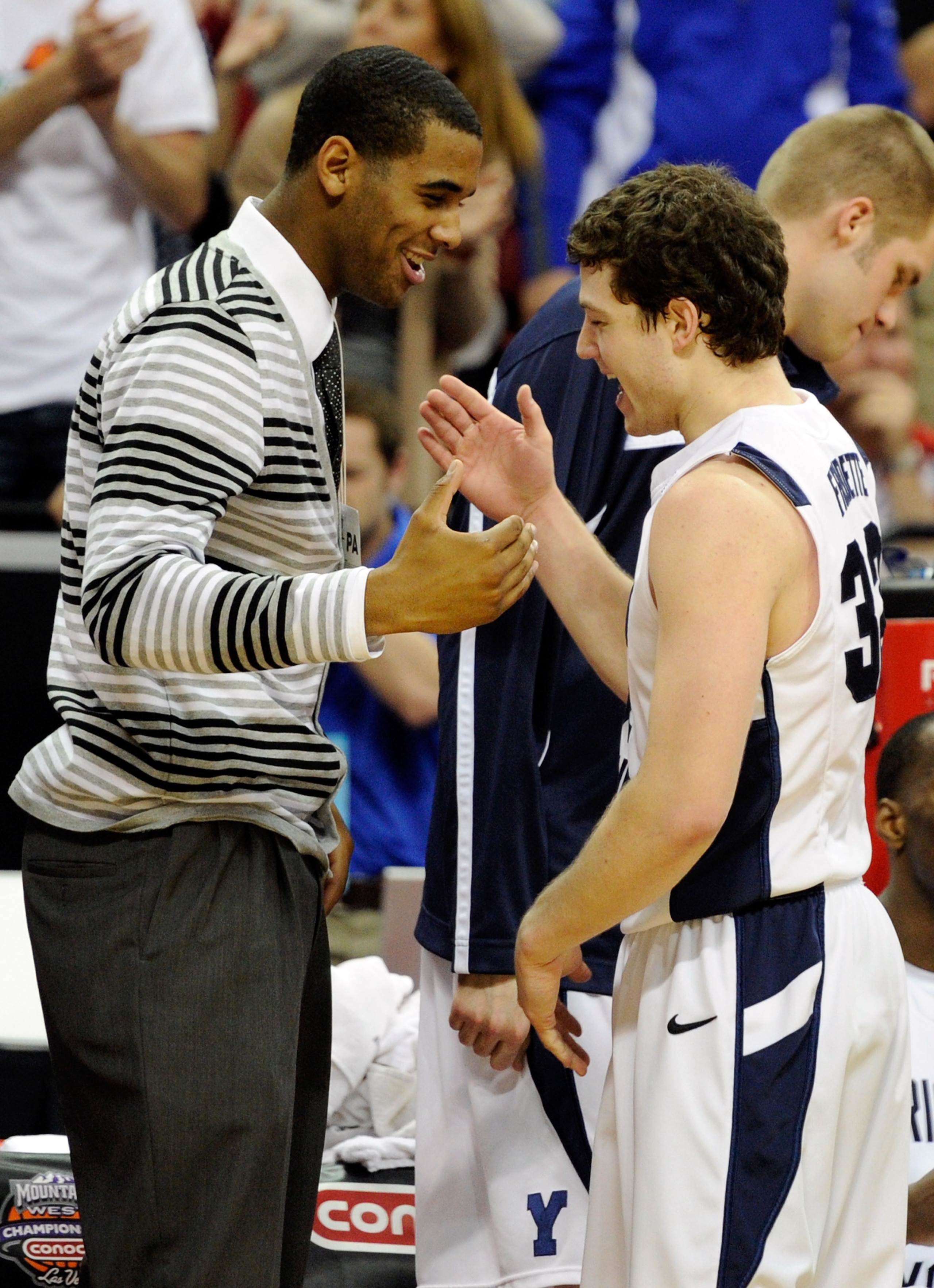 LAS VEGAS, NV - MARCH 11:  Suspended Brigham Young University Cougars player Brandon Davies (L) greets Jimmer Fredette #32 as he comes out of a semifinal game of the Conoco Mountain West Conference Basketball tournament against the New Mexico Lobos at the
