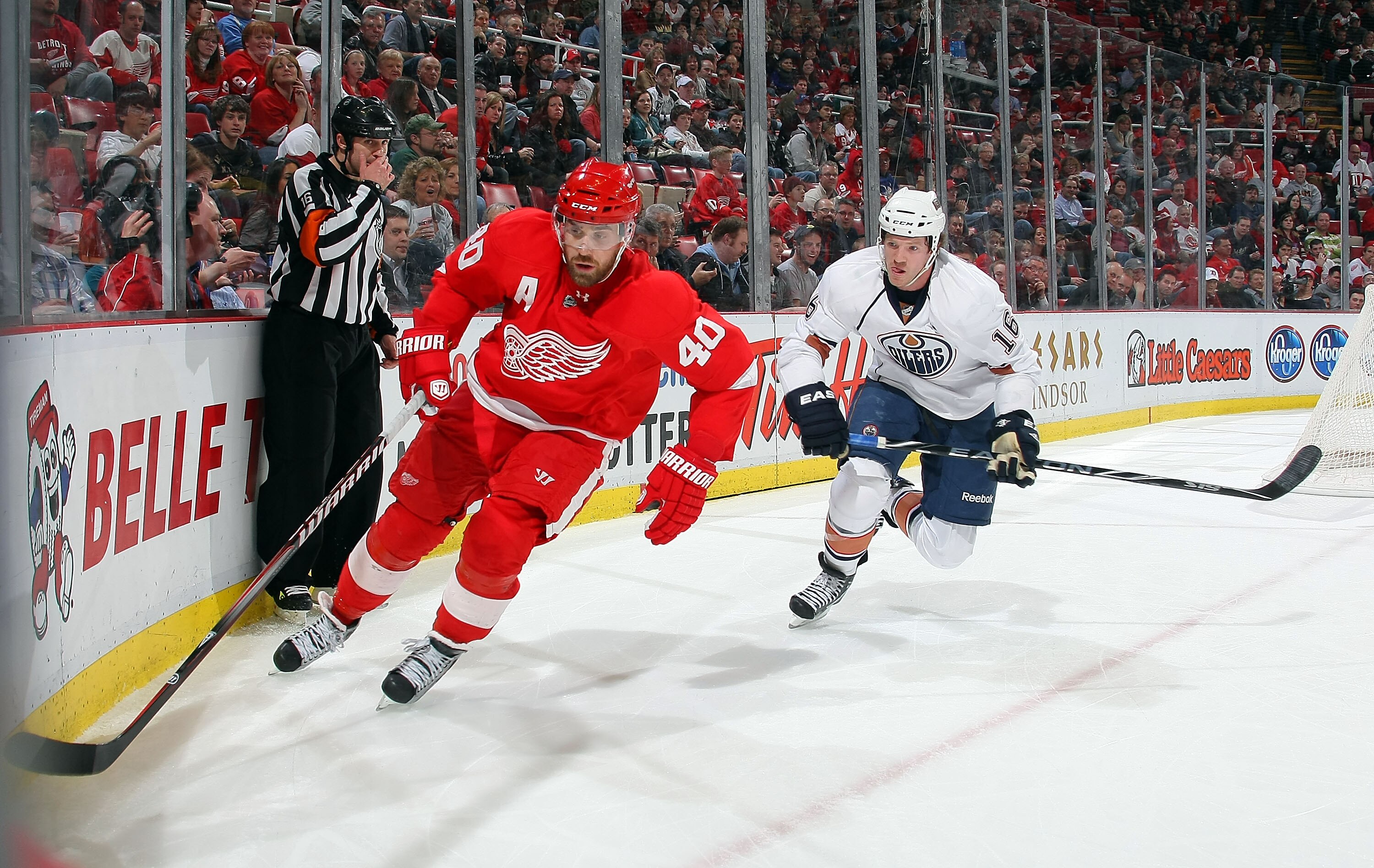 DETROIT, MI - MARCH 11:  Colin Fraser #16 of the Edmonton Oilers battles for the puck with Henrik Zetterberg #40 of the Detroit Red Wings during their NHL game at Joe Louis Arena on March 11, 2011 in Detroit, Michigan.  (Photo by Dave Sandford/Getty Image
