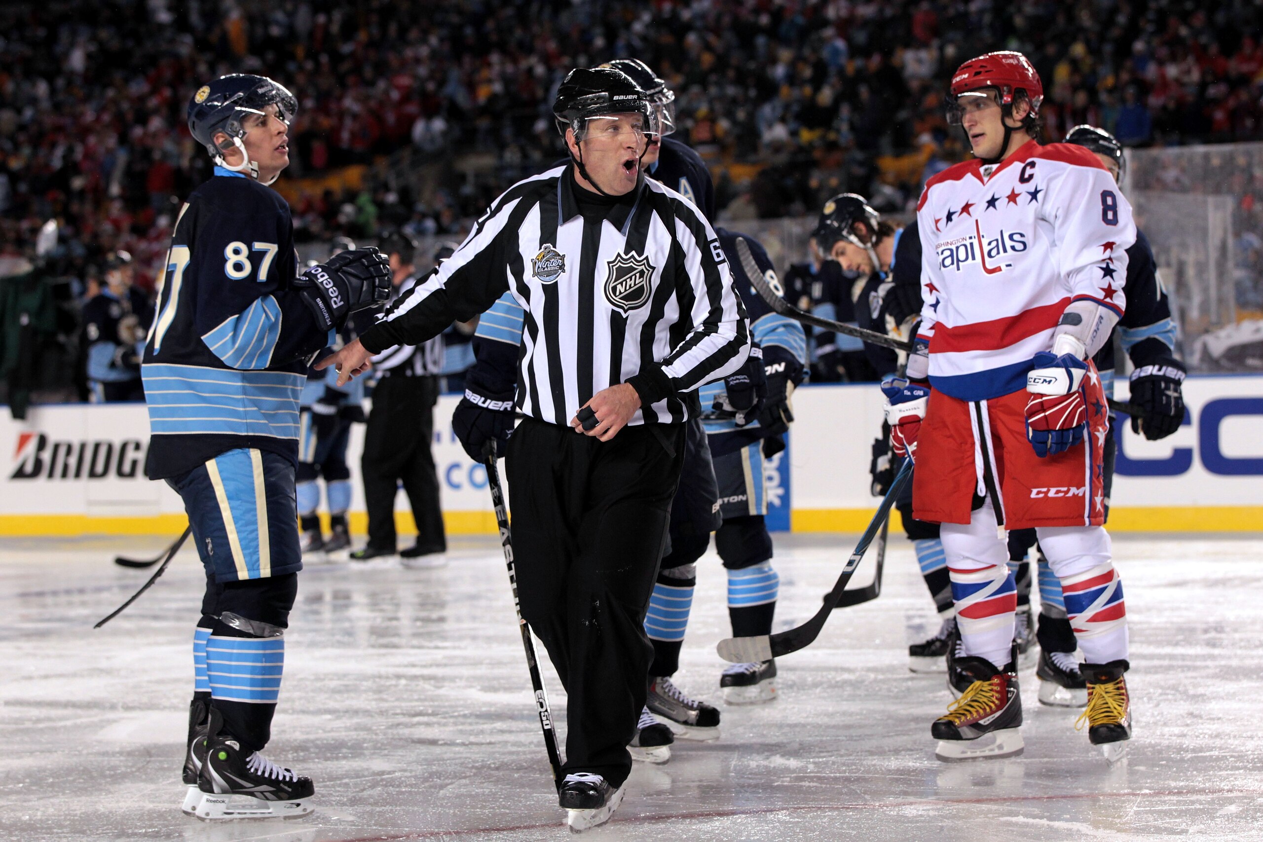 PITTSBURGH, PA - JANUARY 01: Alex Ovechkin #8 of the Washington Capitals and Sidney Crosby #81 of the Pittsburgh Penguins are seperated by a referee during the 2011 NHL Bridgestone Winter Classic at Heinz Field on January 1, 2011 in Pittsburgh, Pennsylva PITTSBURGH, PA - JANUARY 01: Alex Ovechkin #8 of the Washington Capitals and Sidney Crosby #81 of the Pittsburgh Penguins are seperated by a referee during the 2011 NHL Bridgestone Winter Classic at Heinz Field on January 1, 2011 in Pittsburgh, Pennsylva