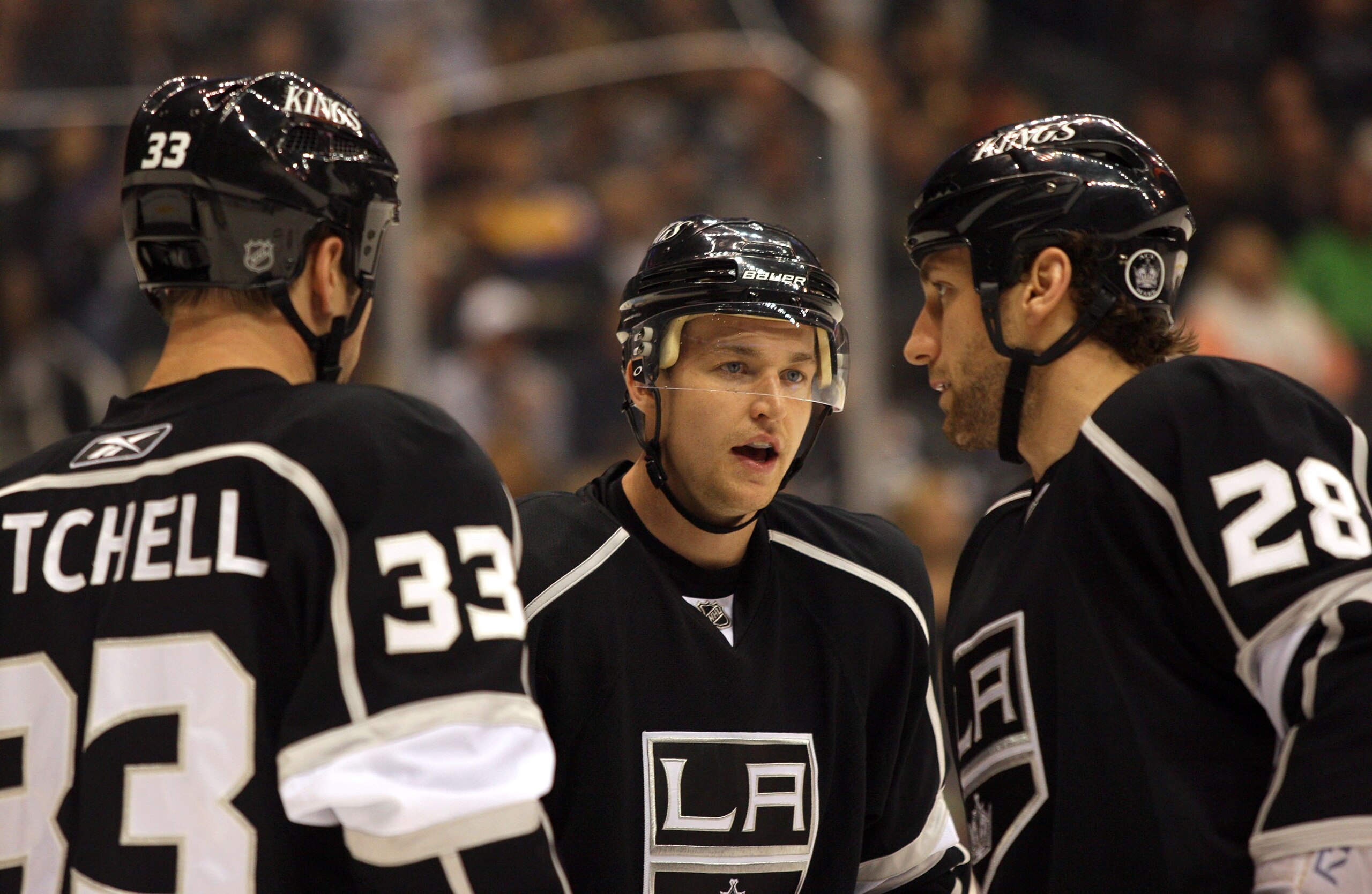 LOS ANGELES, CA - MARCH 03:  Trevor Lewis #22 of the Los Angeles Kings talks to teammates Jarret Stoll #28 and Willie Mitchell #33 prior to a defensive zone faceoff during the NHL game against the Phoenix Coyotes at Staples Center on March 3, 2011 in Los 