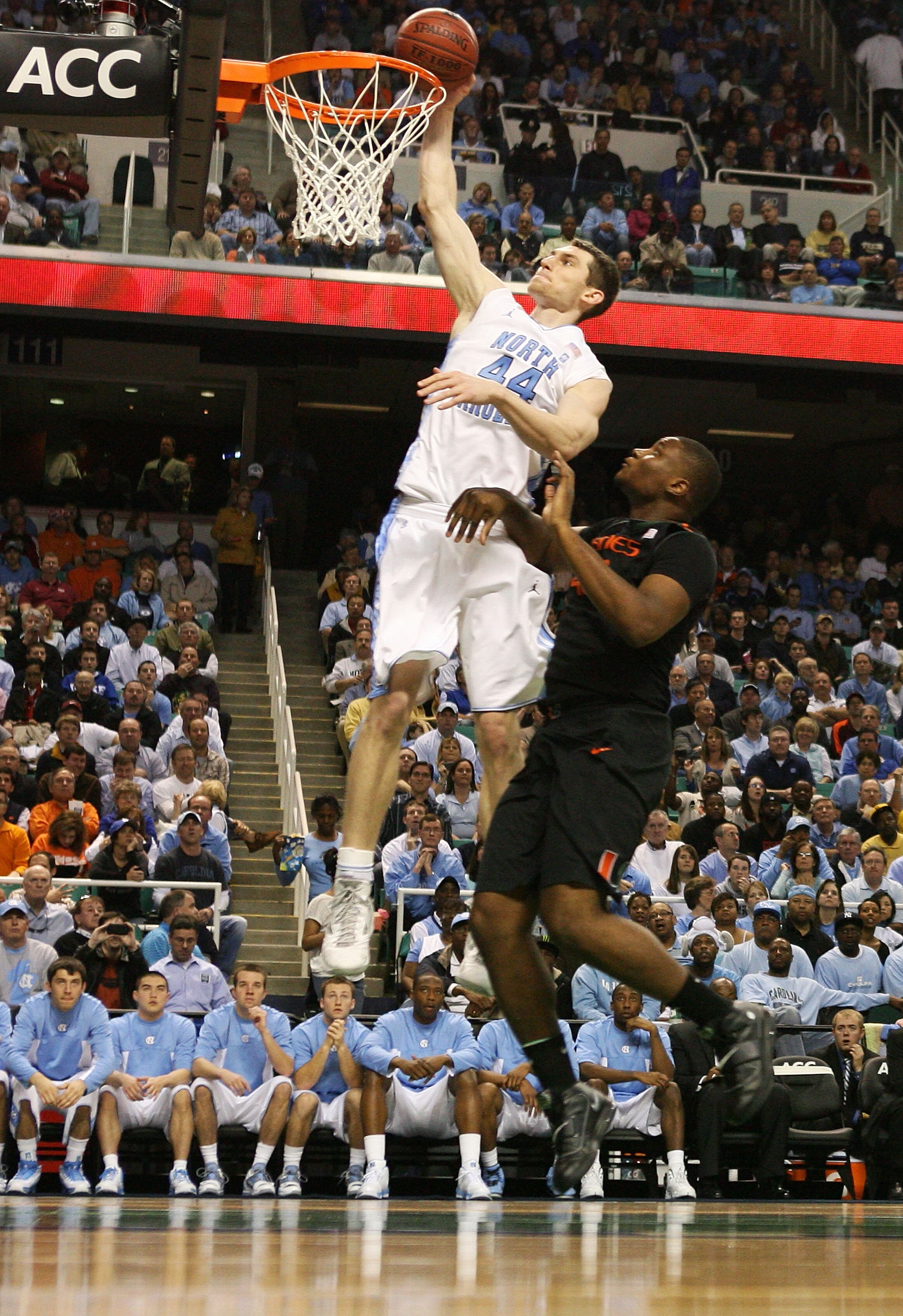 GREENSBORO, NC - MARCH 11:  Tyler Zeller #44 of the North Carolina Tar Heels shoots against Reggie Johnson #42 of the Miami Hurricanes during the second half in the quarterfinals of the 2011 ACC men's basketball tournament at the Greensboro Coliseum on Ma