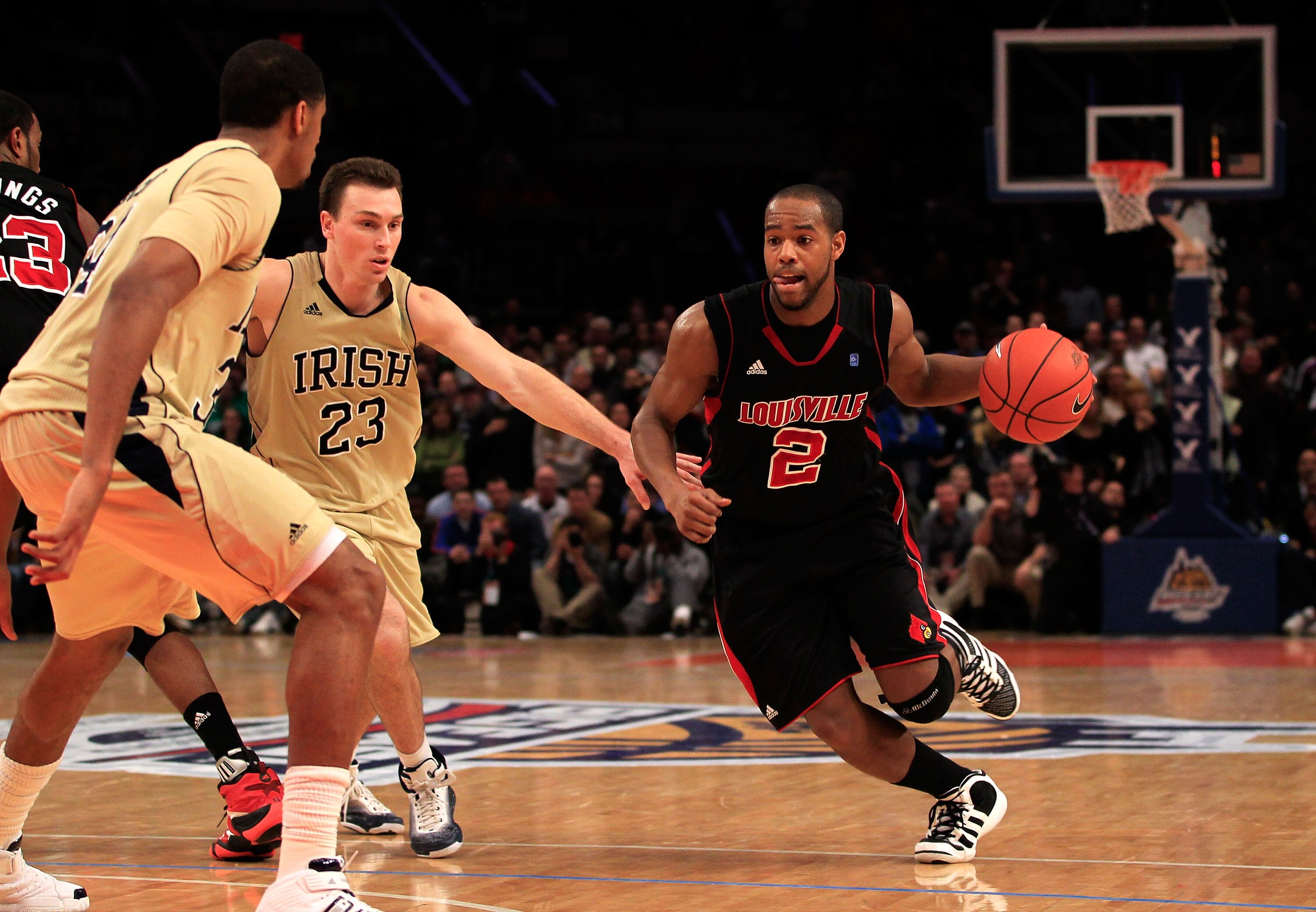 NEW YORK, NY - MARCH 11:  Preston Knowles #2 of the Louisville Cardinals brings the ball up court against Ben Hansbrough #23 of the Notre Dame Fighting Irish during the semifinals of the 2011 Big East Men's Basketball Tournament presented by American Eagl