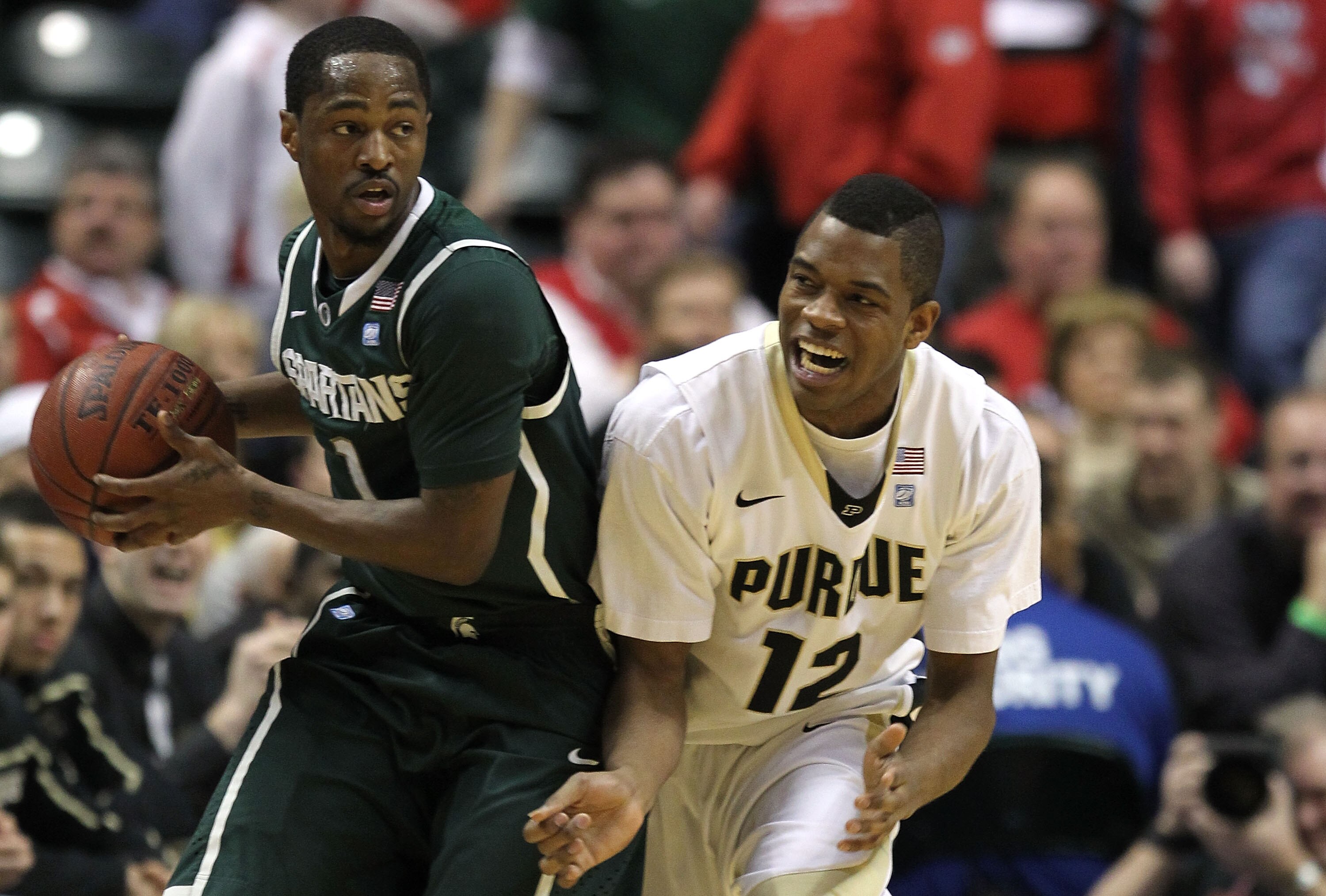 INDIANAPOLIS, IN - MARCH 11:  Kalin Lucas #1 of the Michigan State Spartans looks to pass against Kelsey Barlow #12 of the Purdue Boilermakers during the quarterfinals of the 2011 Big Ten Men's Basketball Tournament at Conseco Fieldhouse on March 11, 2011