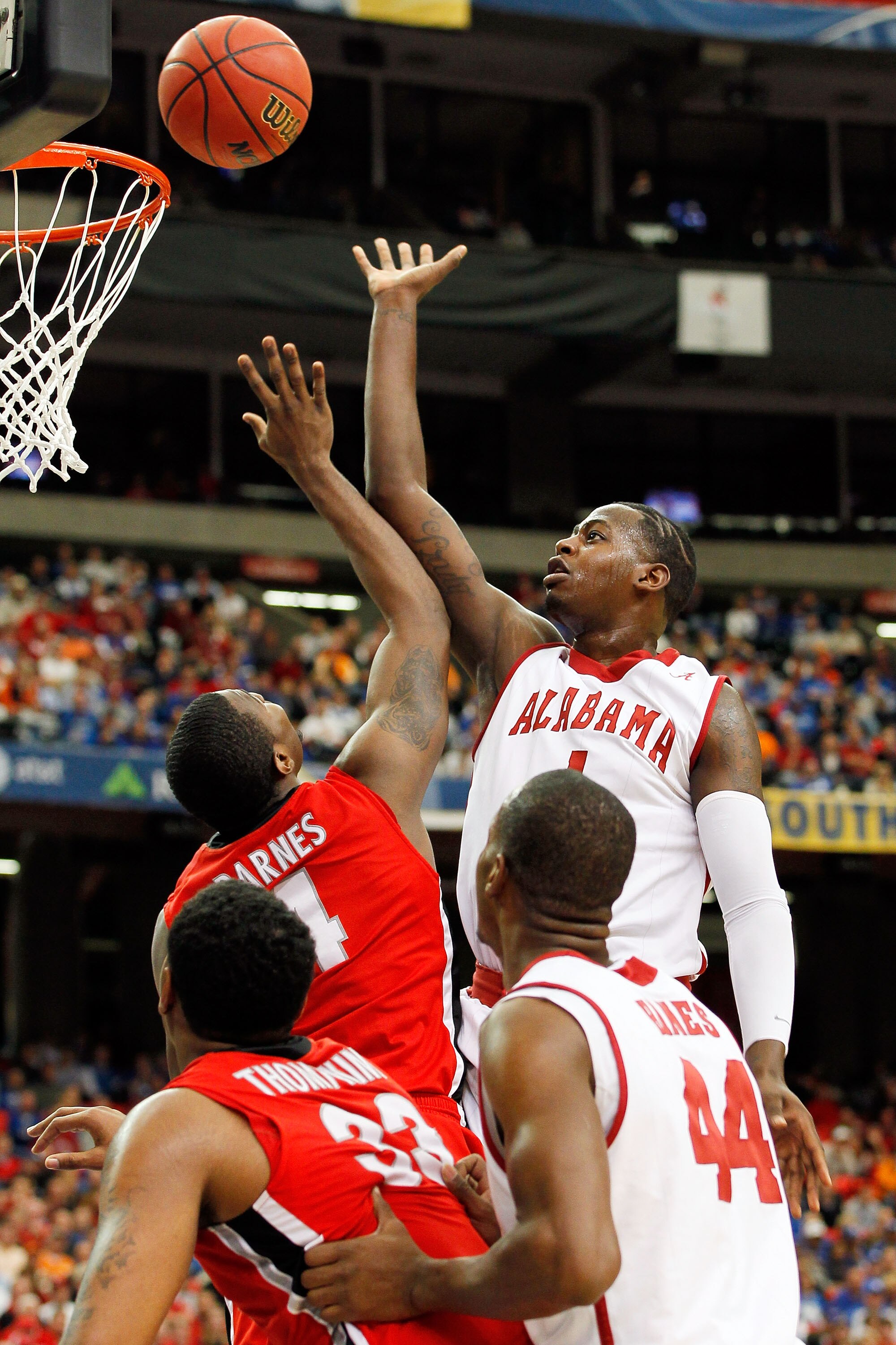 ATLANTA, GA - MARCH 11: JaMychal Green #1 of the Alabama Crimson Tide shoots over Chris Barnes #4 of the Georgia Bulldogs during the quarterfinals of the SEC Men's Basketball Tournament at Georgia Dome on March 11, 2011 in Atlanta, Georgia.  (Photo by Kev
