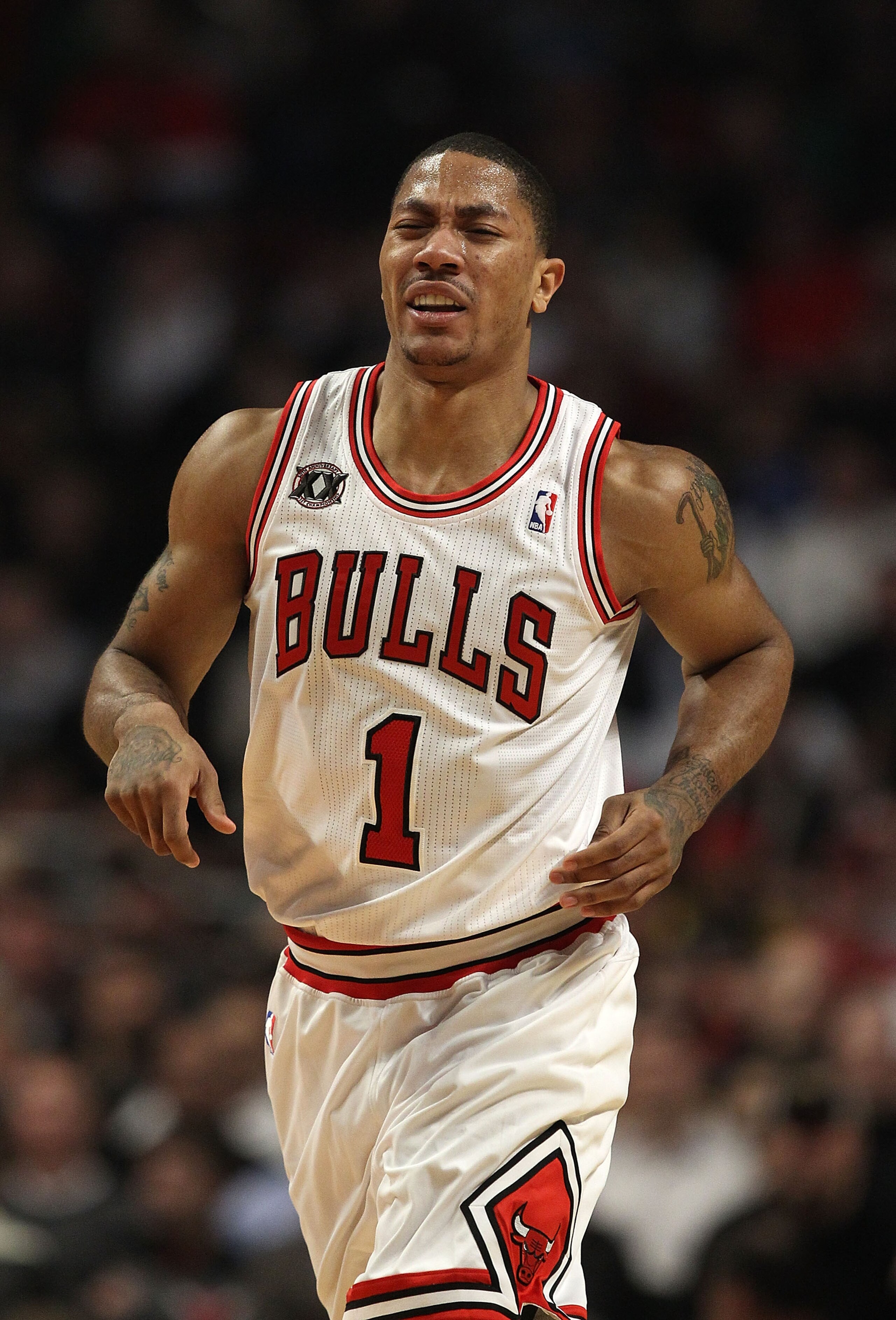 CHICAGO, IL - MARCH 07: Derrick Rose #1 of the Chicago Bulls grimaces as he runs up the court after being poked in the eye on a blocked shot by Emeka Okafor of the New Orleans Hornets at the United Center on March 7, 2011 in Chicago, Illinois. NOTE TO USE