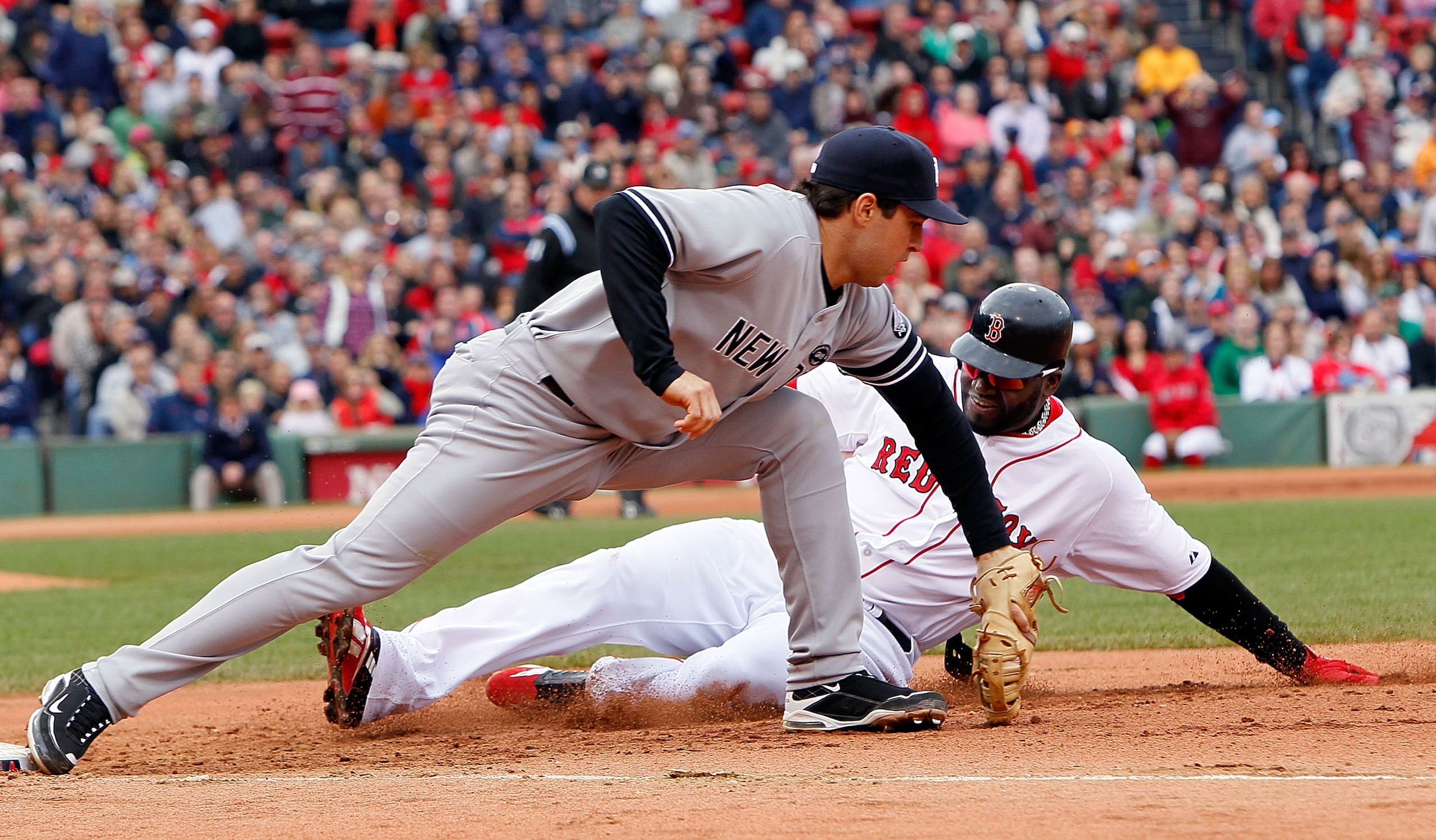 BOSTON - OCTOBER 3:  Mark Teixeira #25 of the New York Yankees executes the second out of a double play on base runner David Ortiz #34 of  the Boston Red Sox, who was caught off of first base, at Fenway Park, October 3, 2010, in Boston, Massachusetts. (Ph