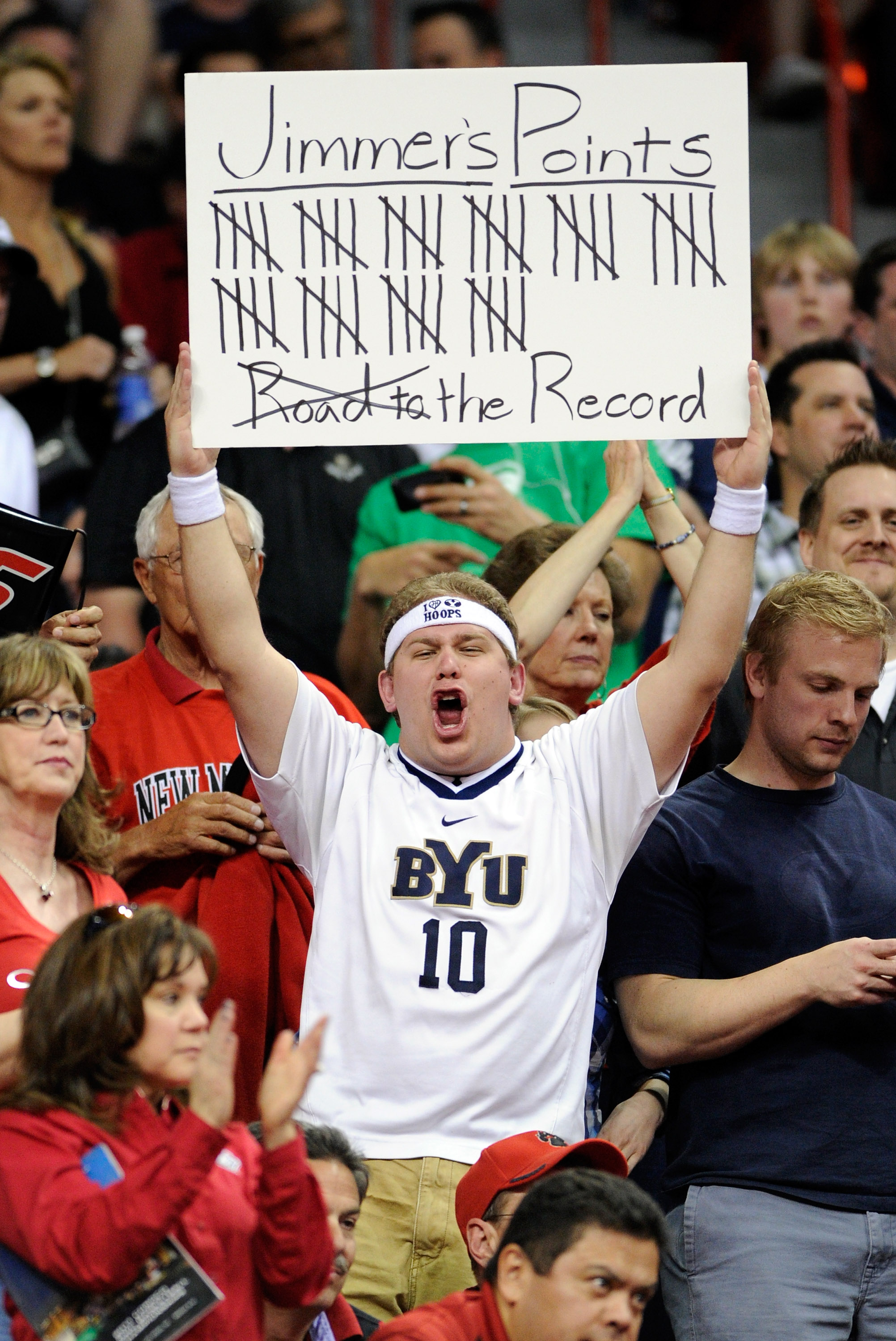 LAS VEGAS, NV - MARCH 11:  A fan keeps track of points scored by Jimmer Fredette #32 of the Brigham Young University Cougars during a semifinal game of the Conoco Mountain West Conference Basketball tournament against the New Mexico Lobos at the Thomas &