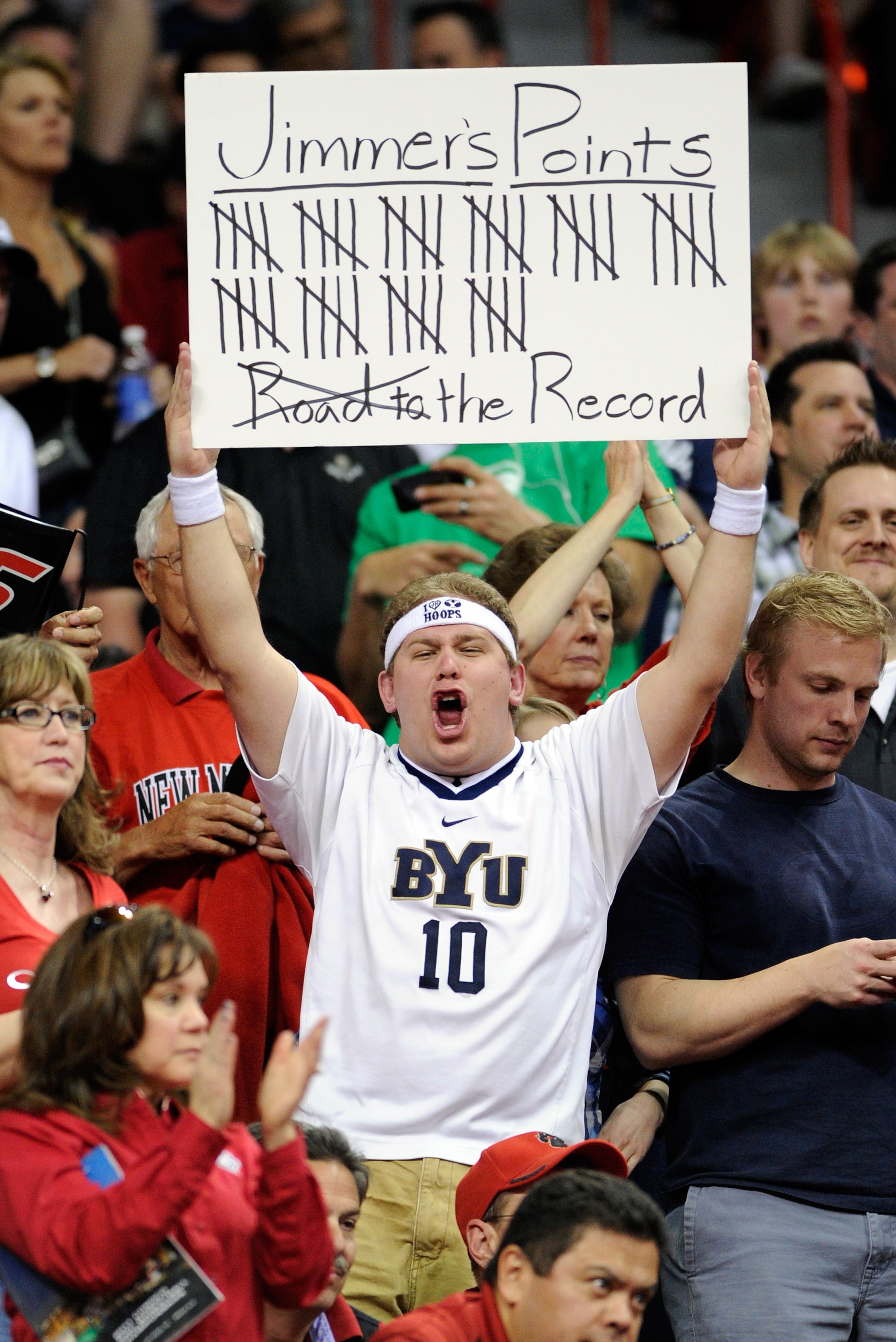 LAS VEGAS, NV - MARCH 11:  A fan keeps track of points scored by Jimmer Fredette #32 of the Brigham Young University Cougars during a semifinal game of the Conoco Mountain West Conference Basketball tournament against the New Mexico Lobos at the Thomas &